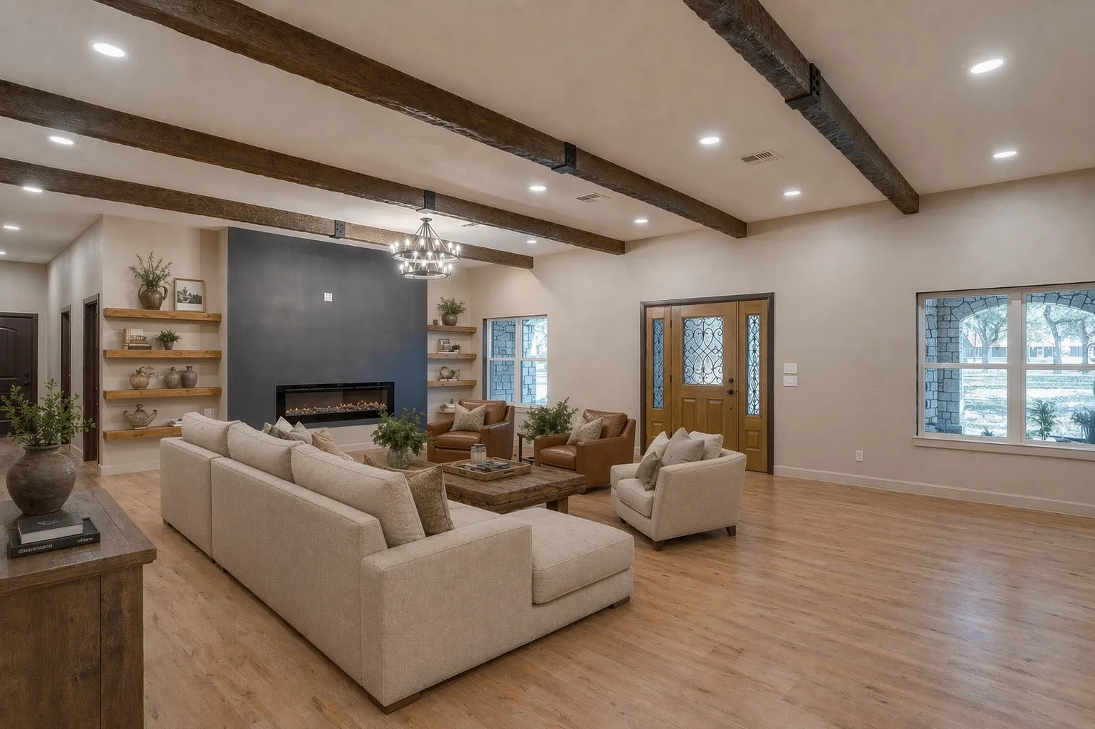 VIRTUALLY STAGED: Spacious living area featuring exposed wood ceiling beams, recessed lighting,light wood-finish flooring with the ambiance of a large electric fireplace.