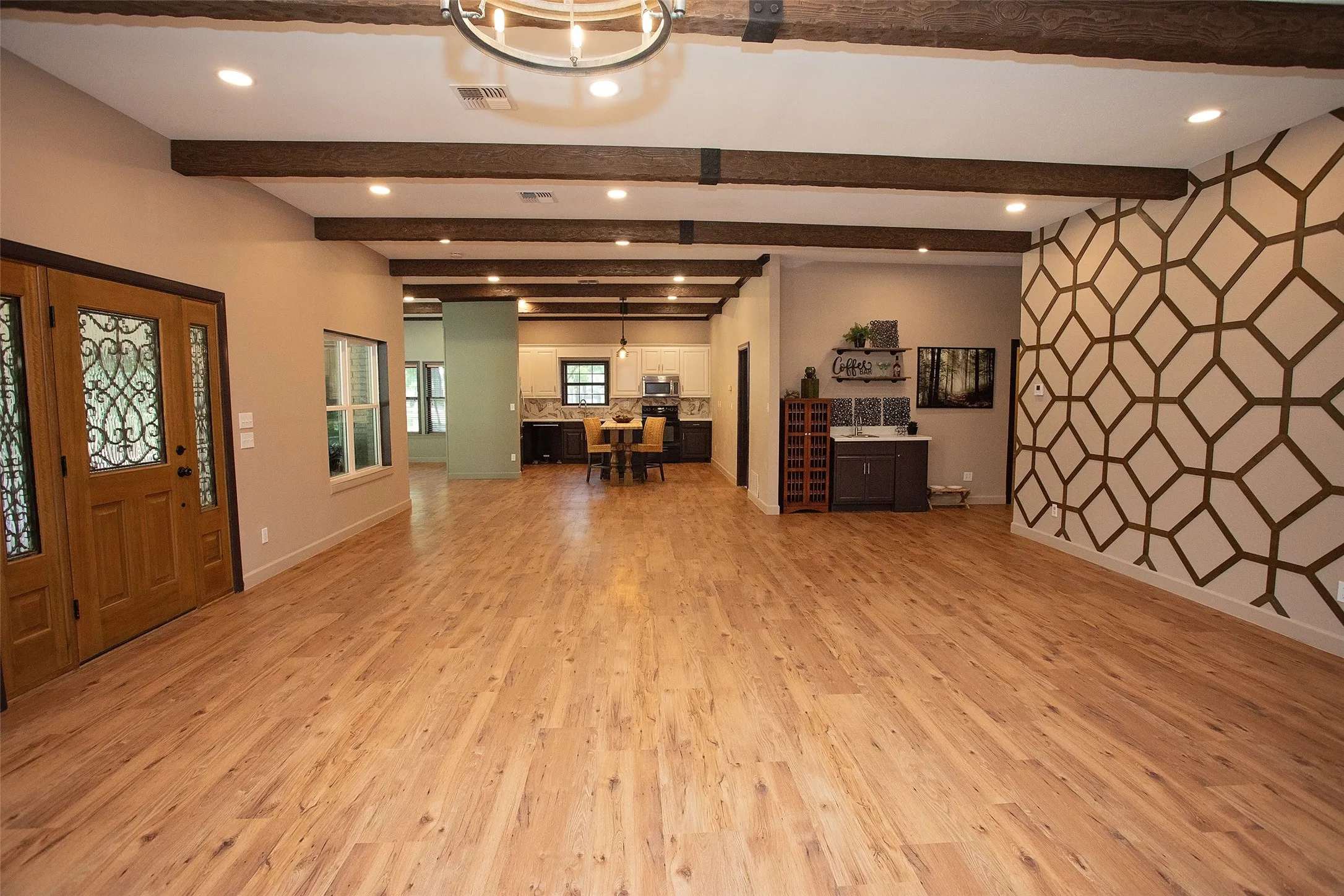 View of Living Room open to the kitchen and wet bar from the hallway.