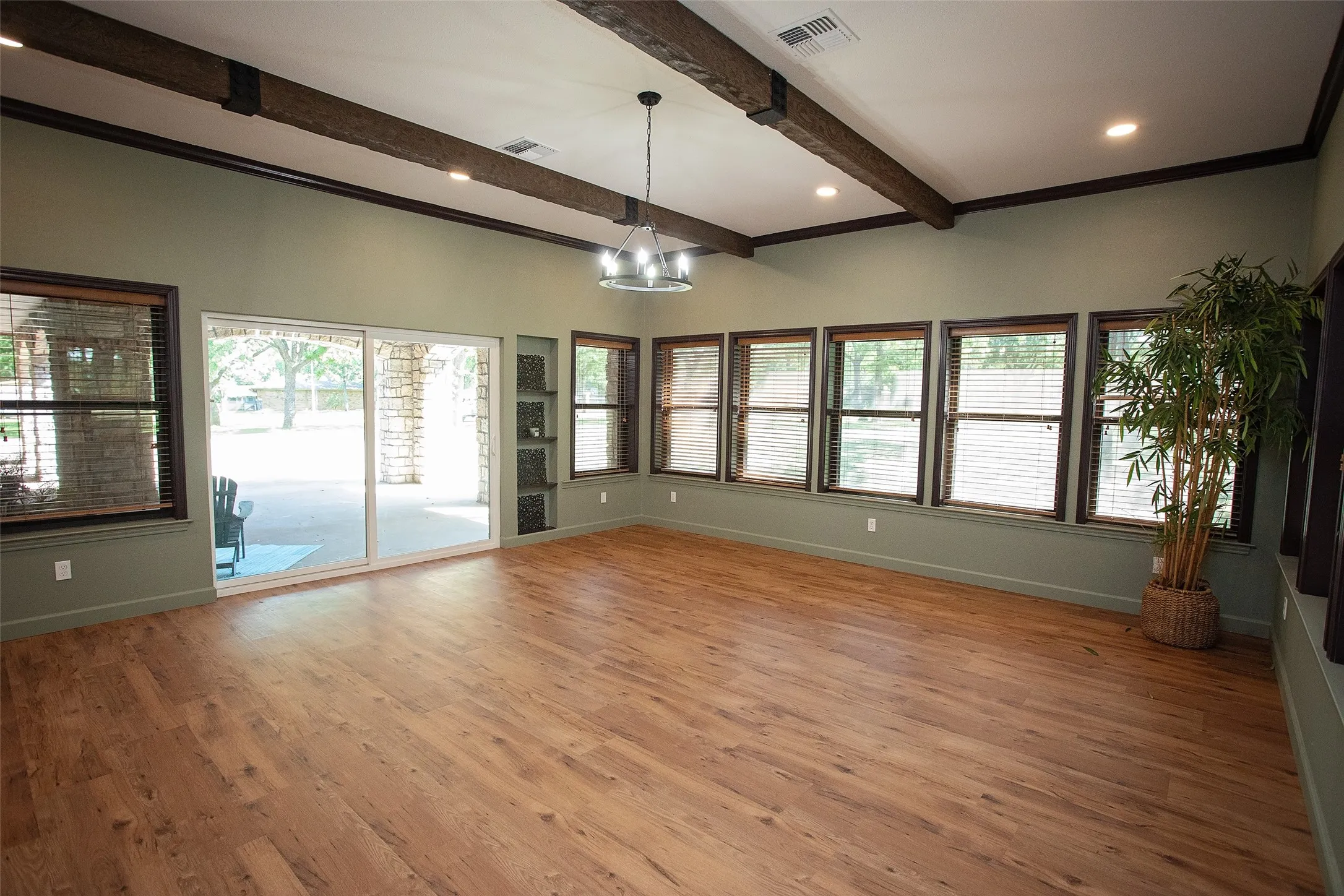 Bright, window-lined space filled with natural light and direct access to the covered front patio through sliding glass doors. Open to the kitchen, this versatile area offers flexibility for a dining room, second living area, or family room, all while taking advantage of the expansive windows and inviting layout.