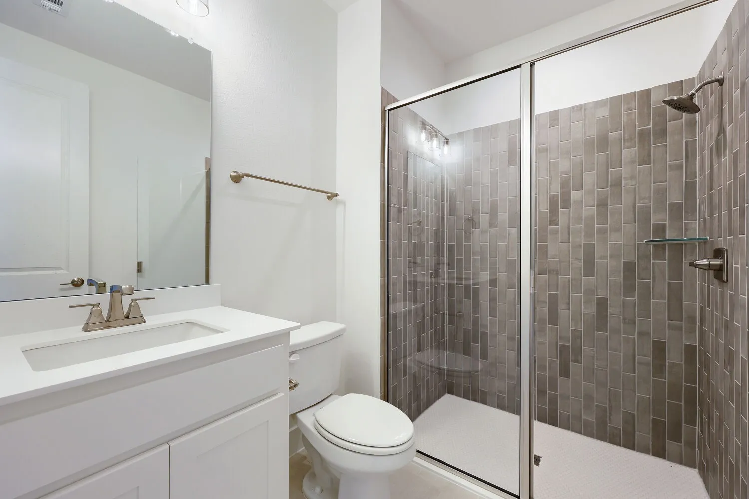 White vanity with integrated sink and brushed nickel faucet