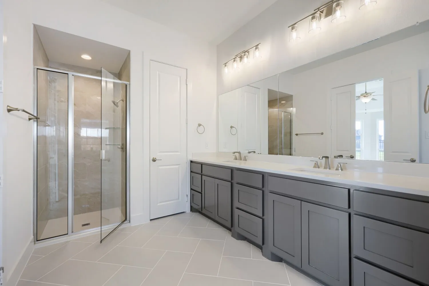 Dual vanity with white countertops, undermount sinks, and brushed nickel fixtures