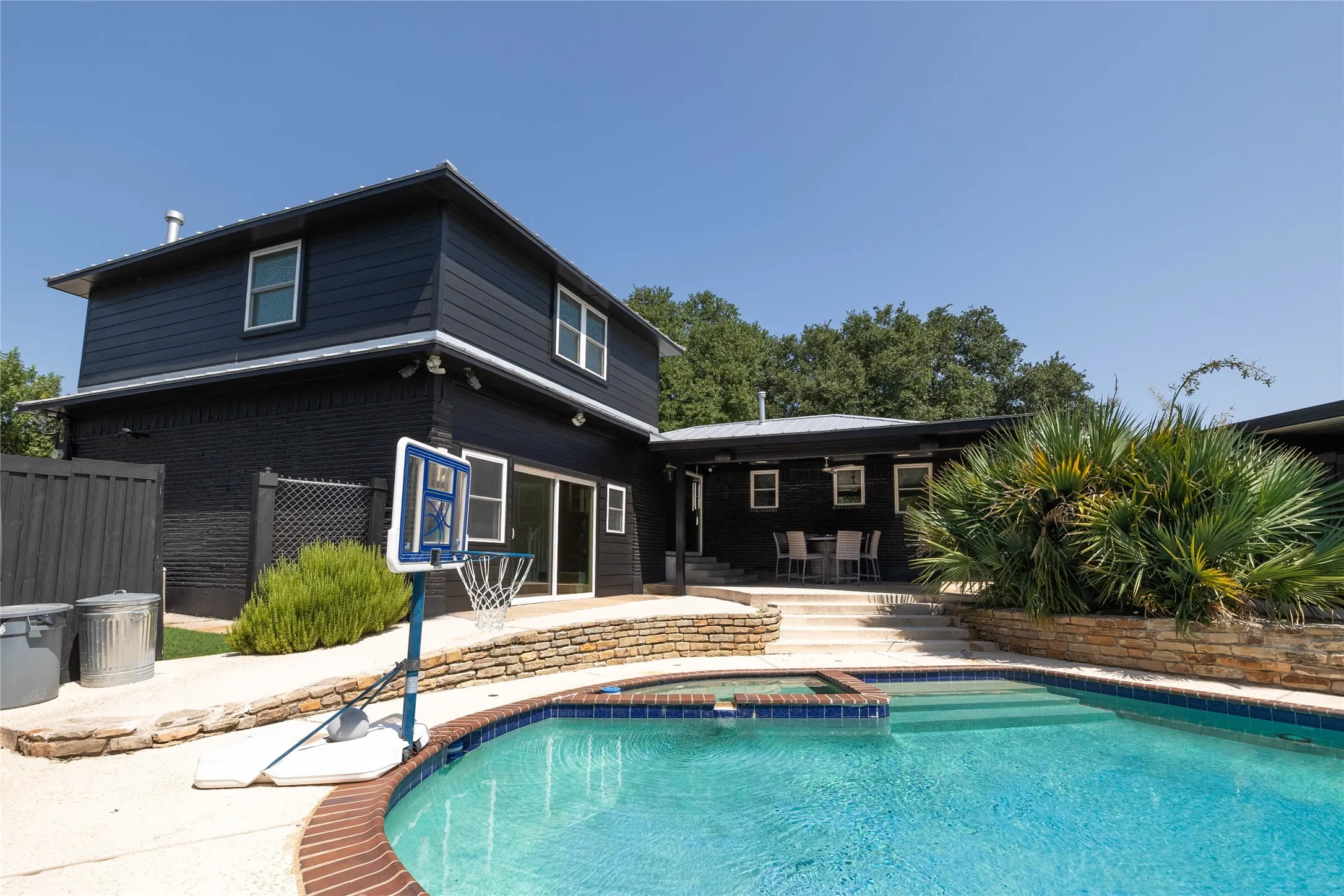 Backyard featuring a built-in swimming pool with an integrated spa