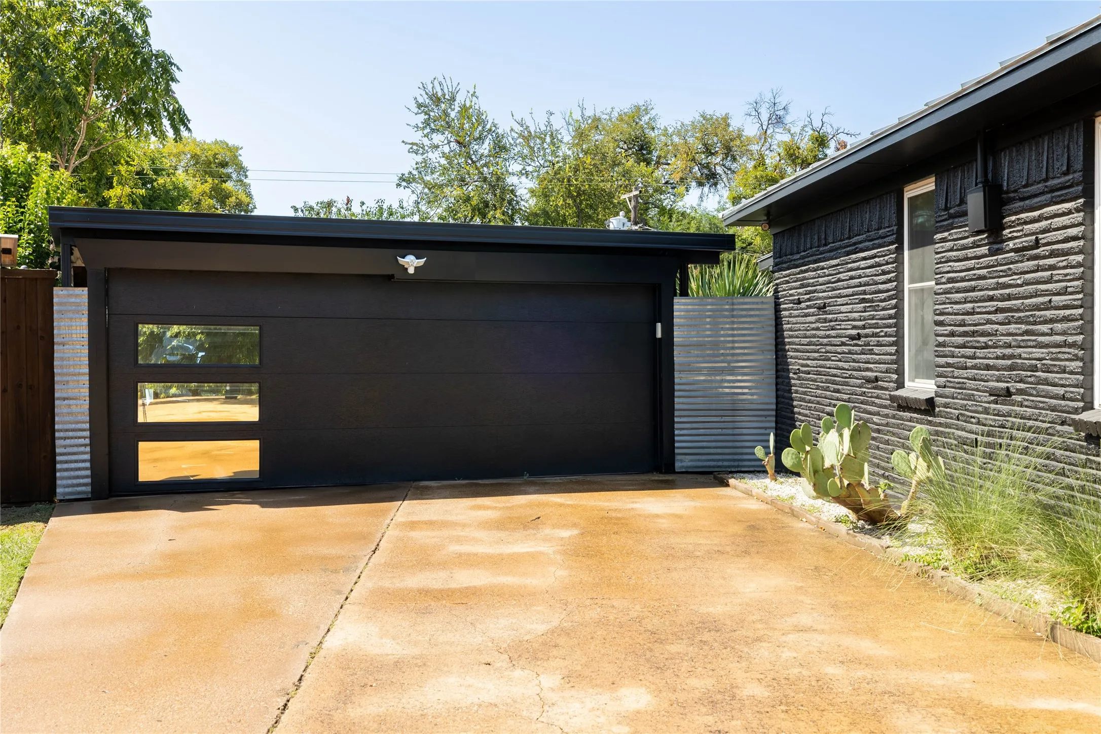 Contemporary black garage with horizontal paneling and three rectangular glass inserts