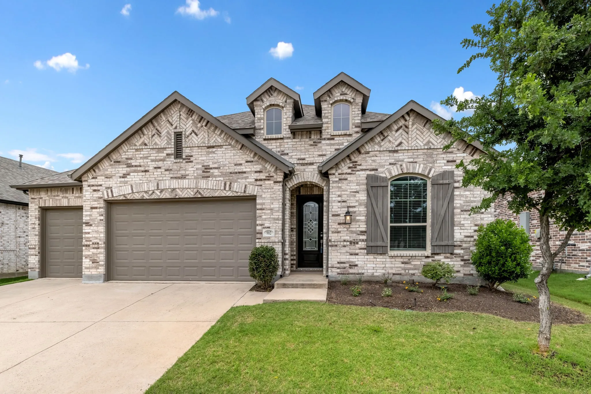Cream brick facade with decorative herringbone accents