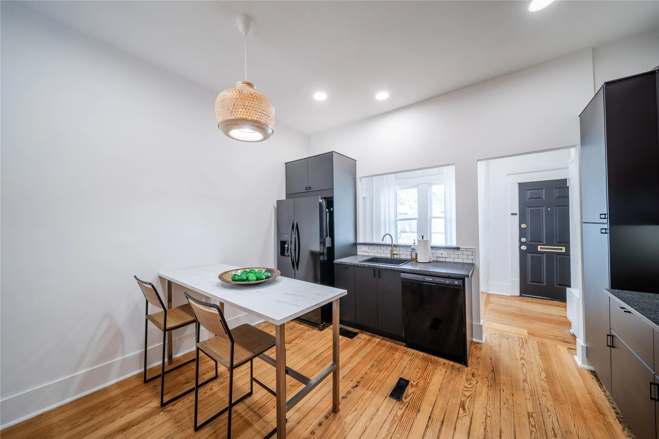 The kitchen on the first level features a refrigerator, sink, dish washer and plenty of storage. The room just beyond the kitchen is the back door entrance room.