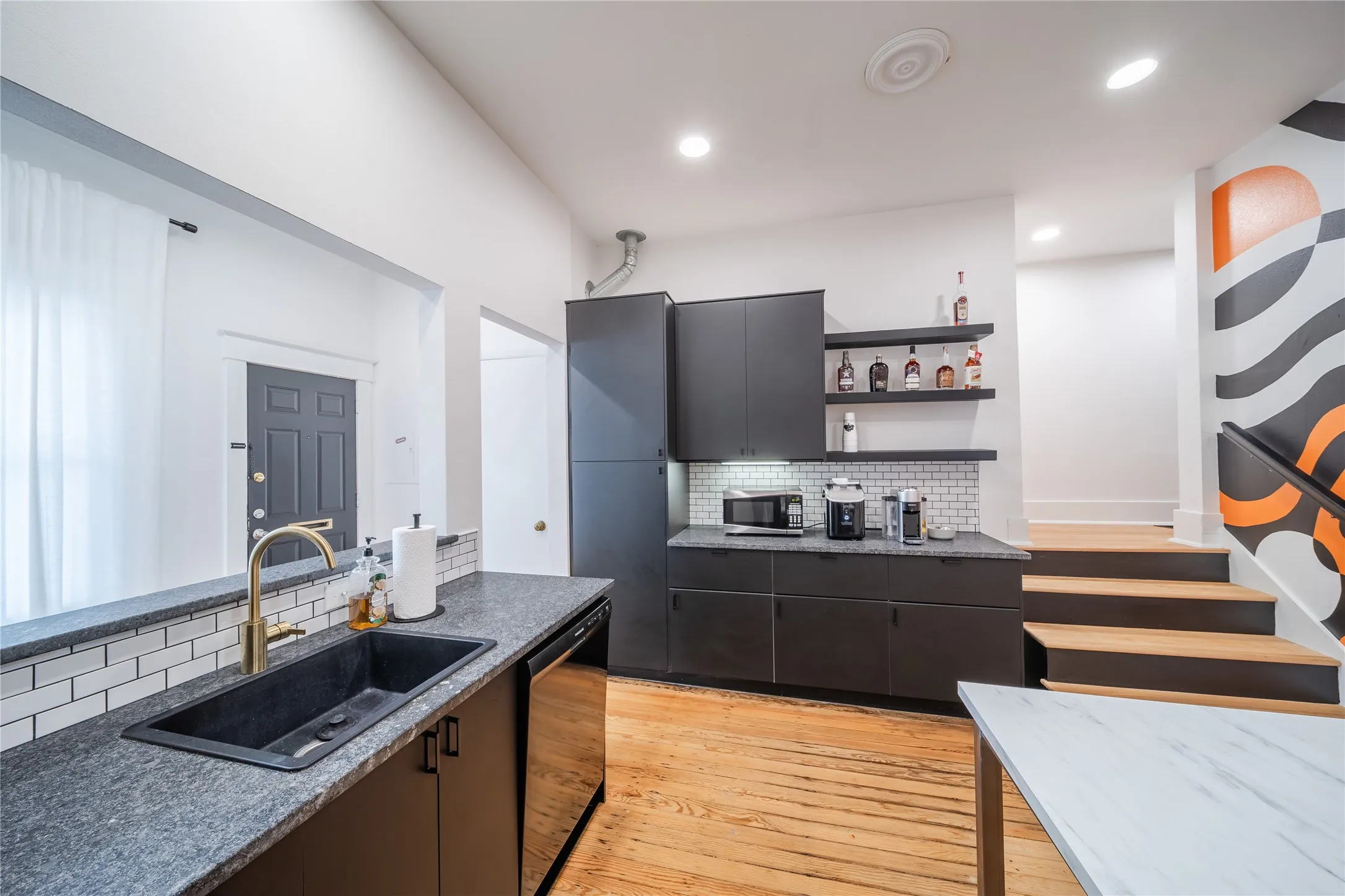 The spacious kitchen on the first level. The stairs in the photo are the internal stairs to access the second level.