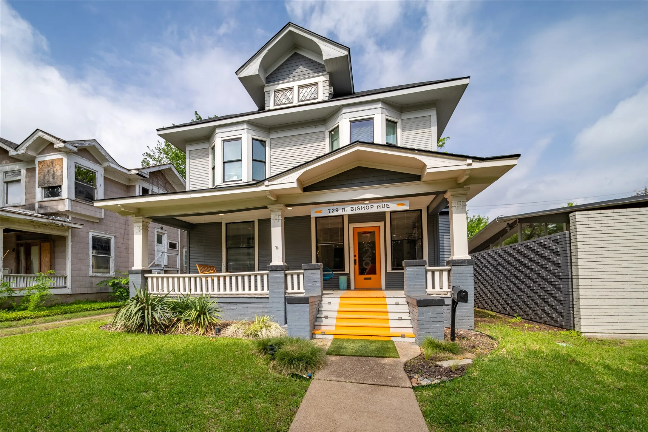 729 N Bishop Ave features a full front porch and dual bay windows on the second level.