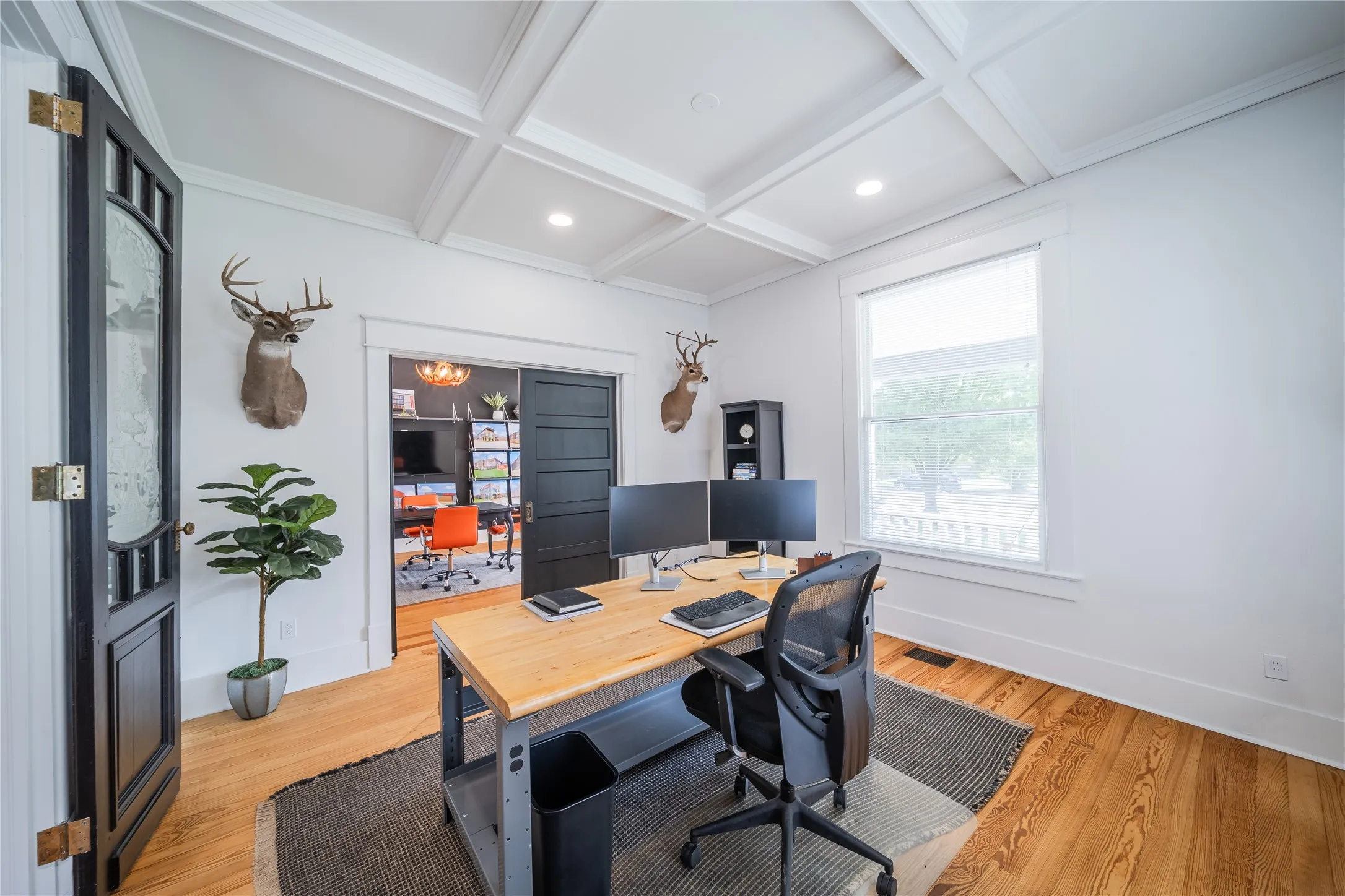 Front office with views to the front porch in the window to the right. This room features original wood panel pocket doors connecting to the front entrance.