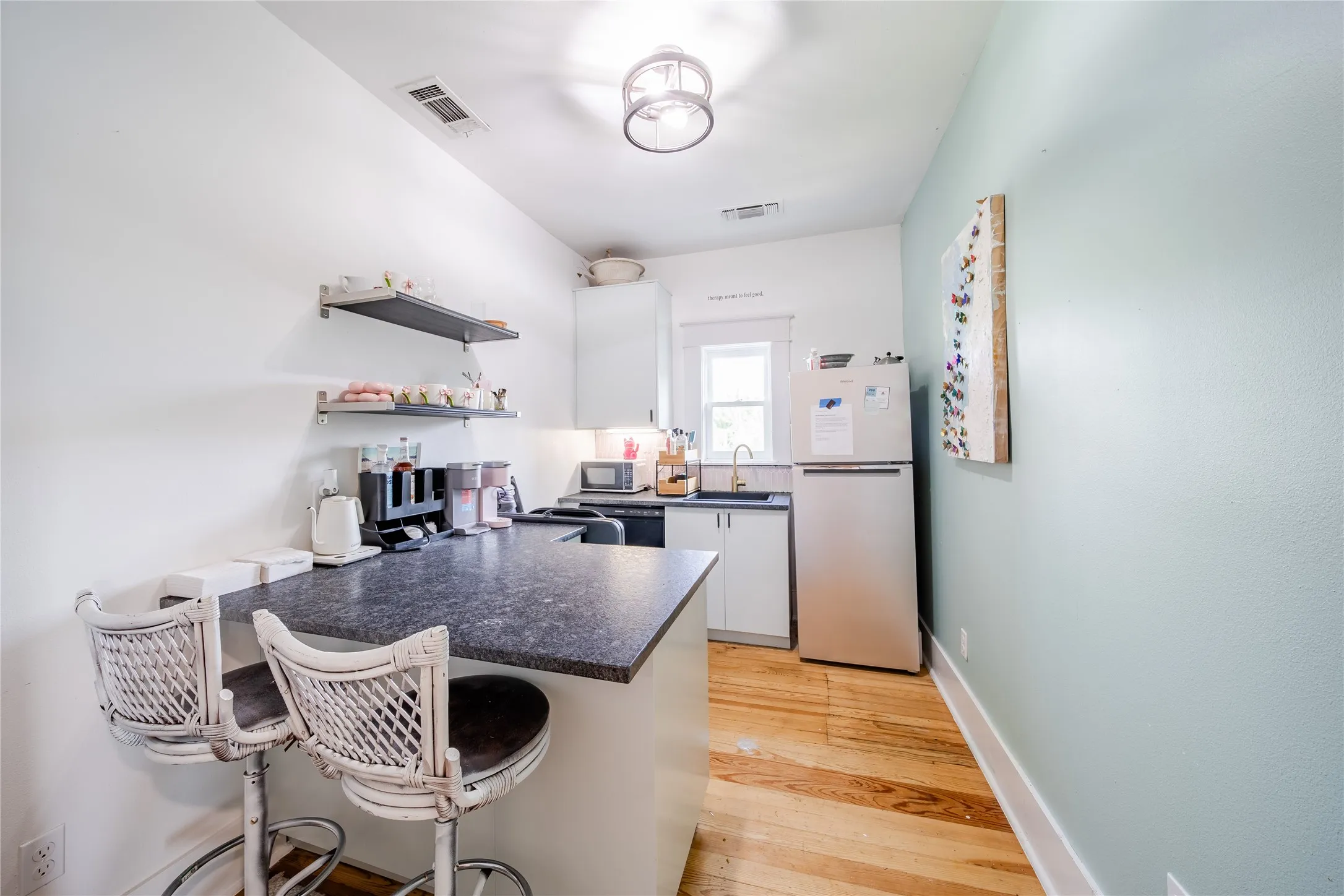 The kitchenette on the second level features a refrigerator, sink and dish washer.
