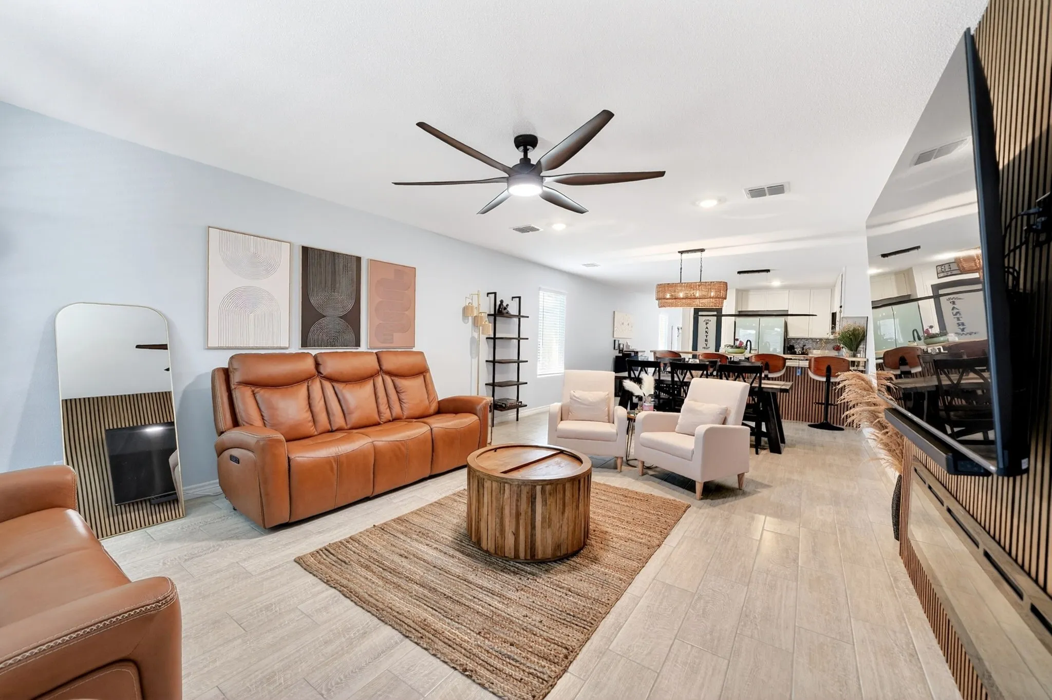 Open-concept living space featuring wood-finish flooring, recessed lighting, and a modern ceiling fan