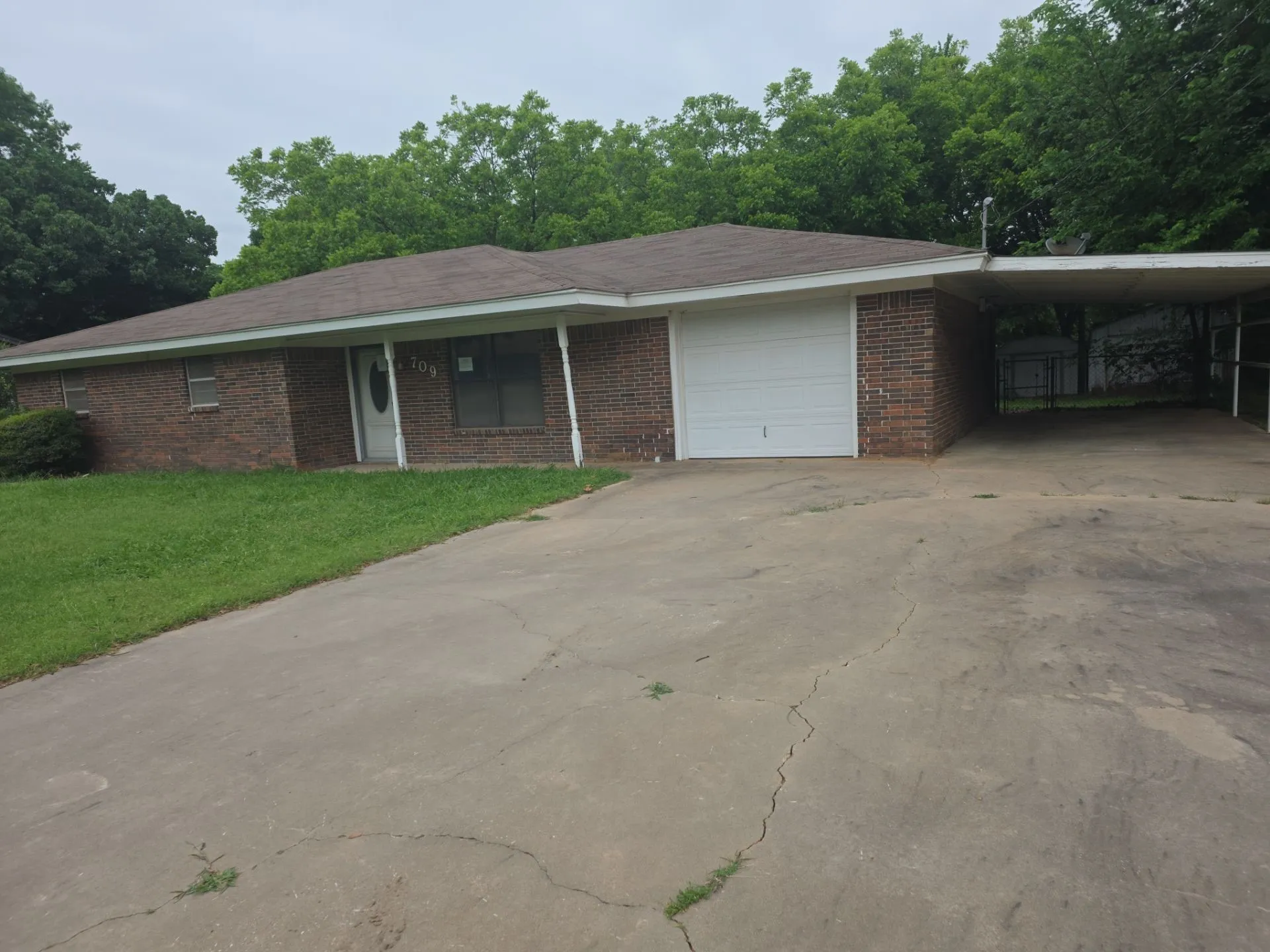 Brick exterior with a covered front entry and an attached garage