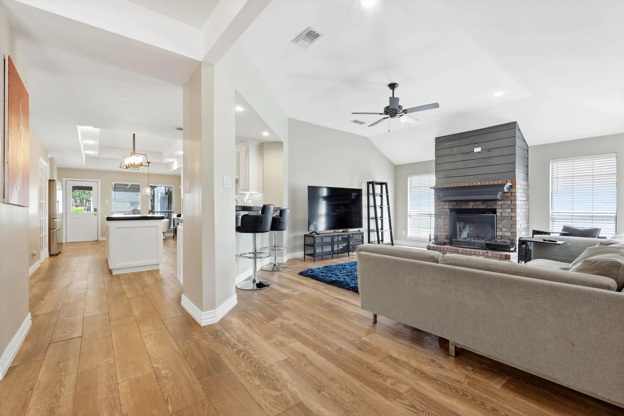 The open-concept design and cozy fireplace create a welcoming space where everyone naturally comes together after a long day.
