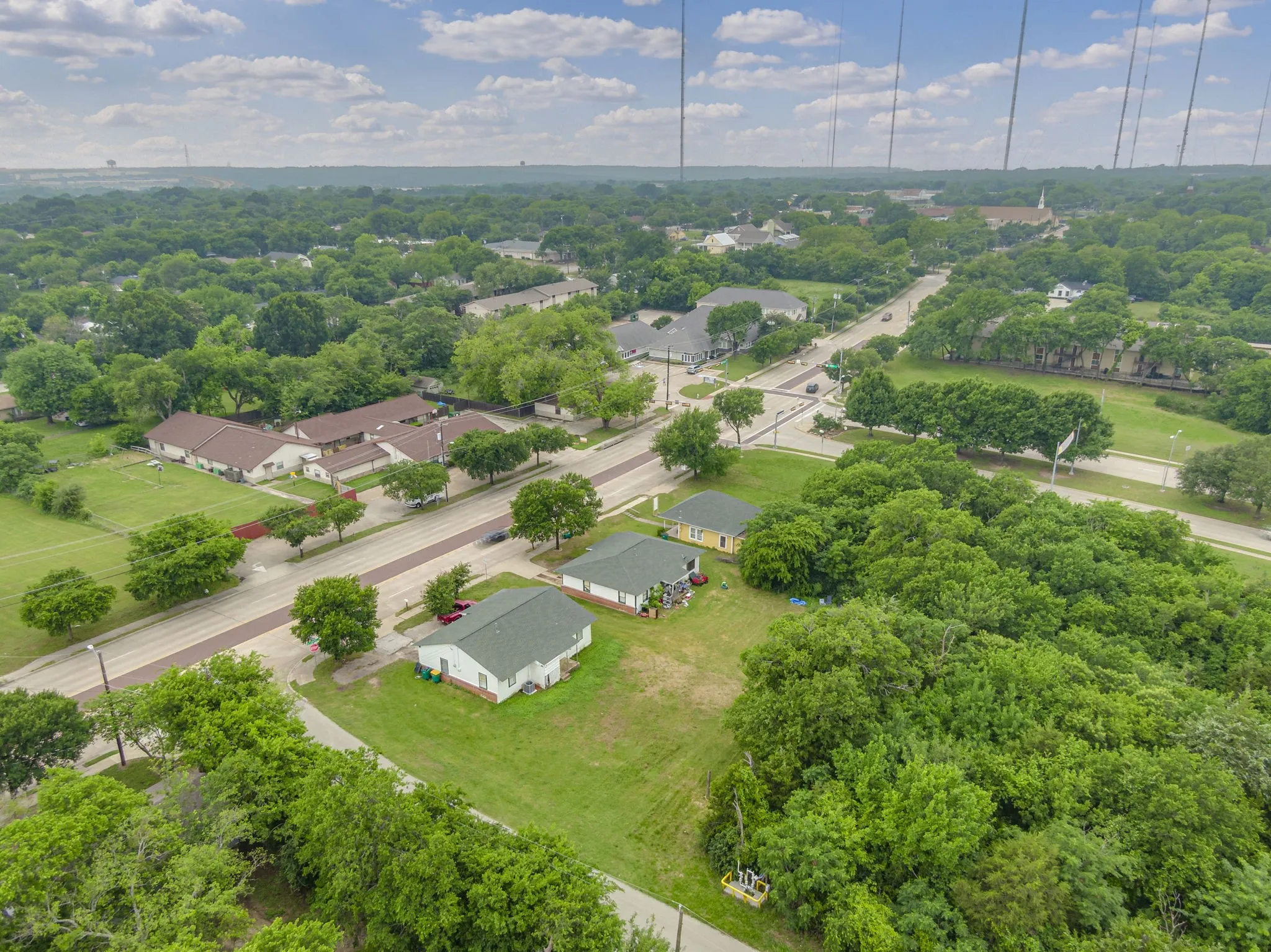 Aerial perspective showcasing a residential area with mature trees and established properties
