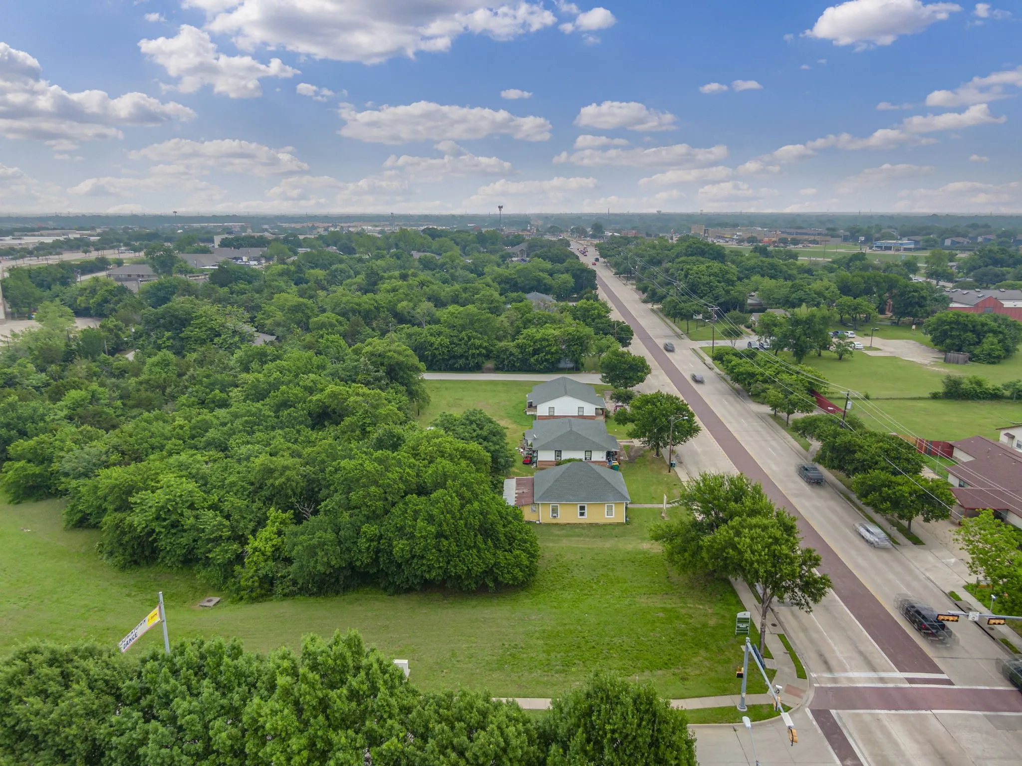Aerial overview showcasing a substantial undeveloped lot with extensive tree coverage