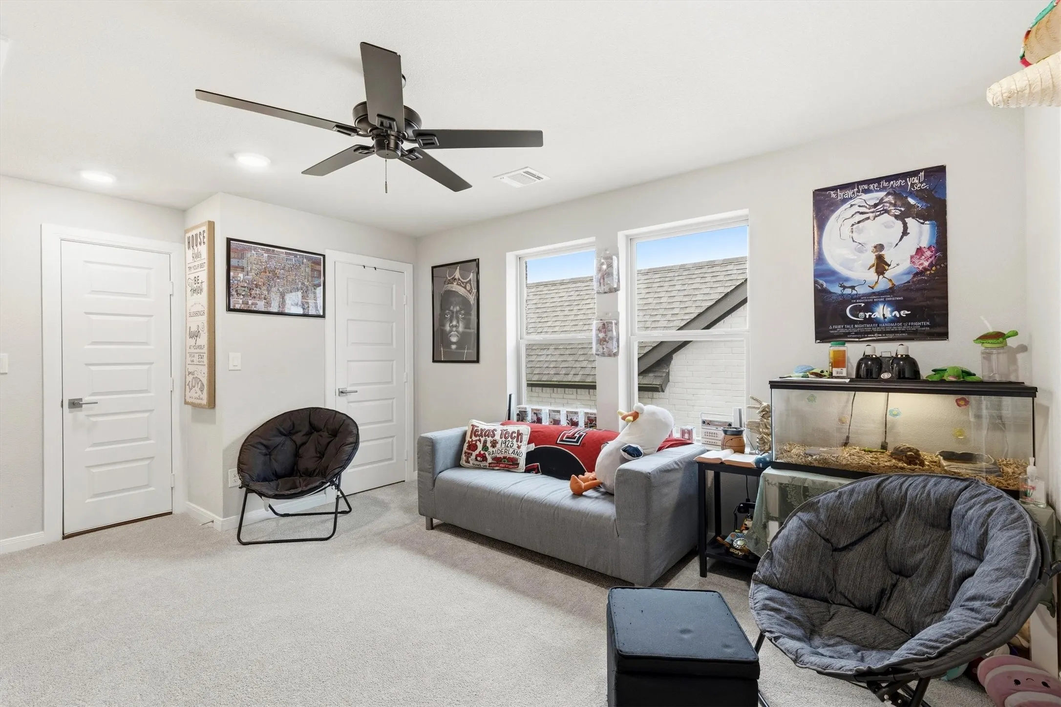 The second floor living room is spacious with a ceiling fan and closet storage space