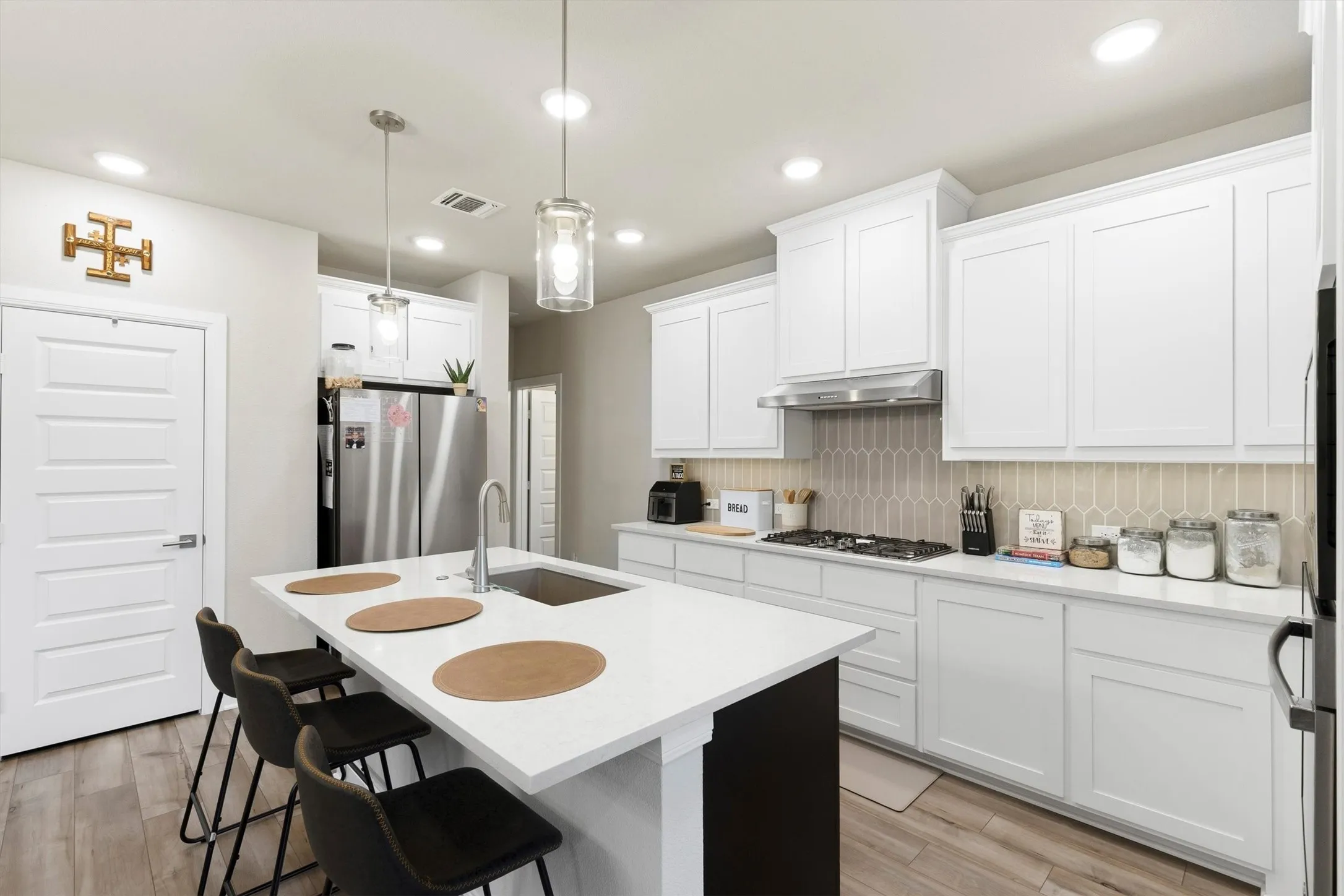 White cabinets and counter tops create a bright kitchen