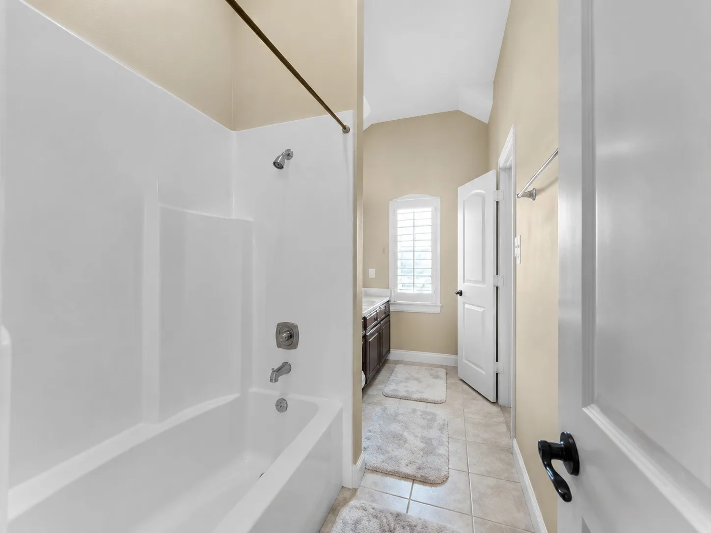 Hallbathroom that joins with bedroom 3, White tub and shower combination with chrome fixtures