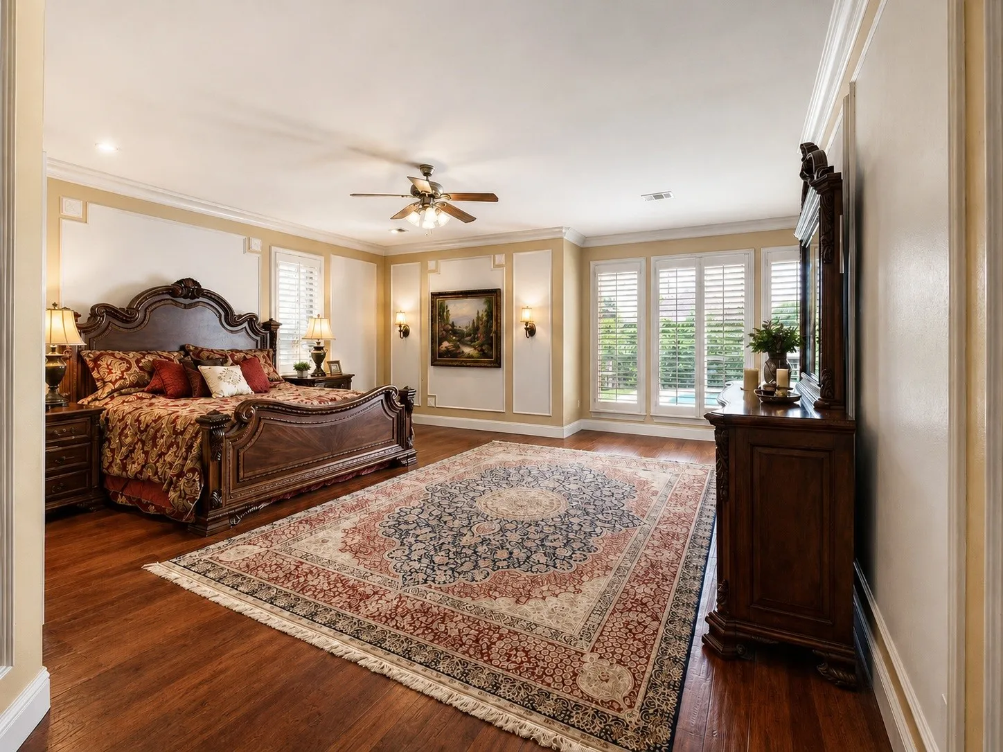 Hardwood-finish flooring, recessed lighting, ceiling fan, and wall sconces
