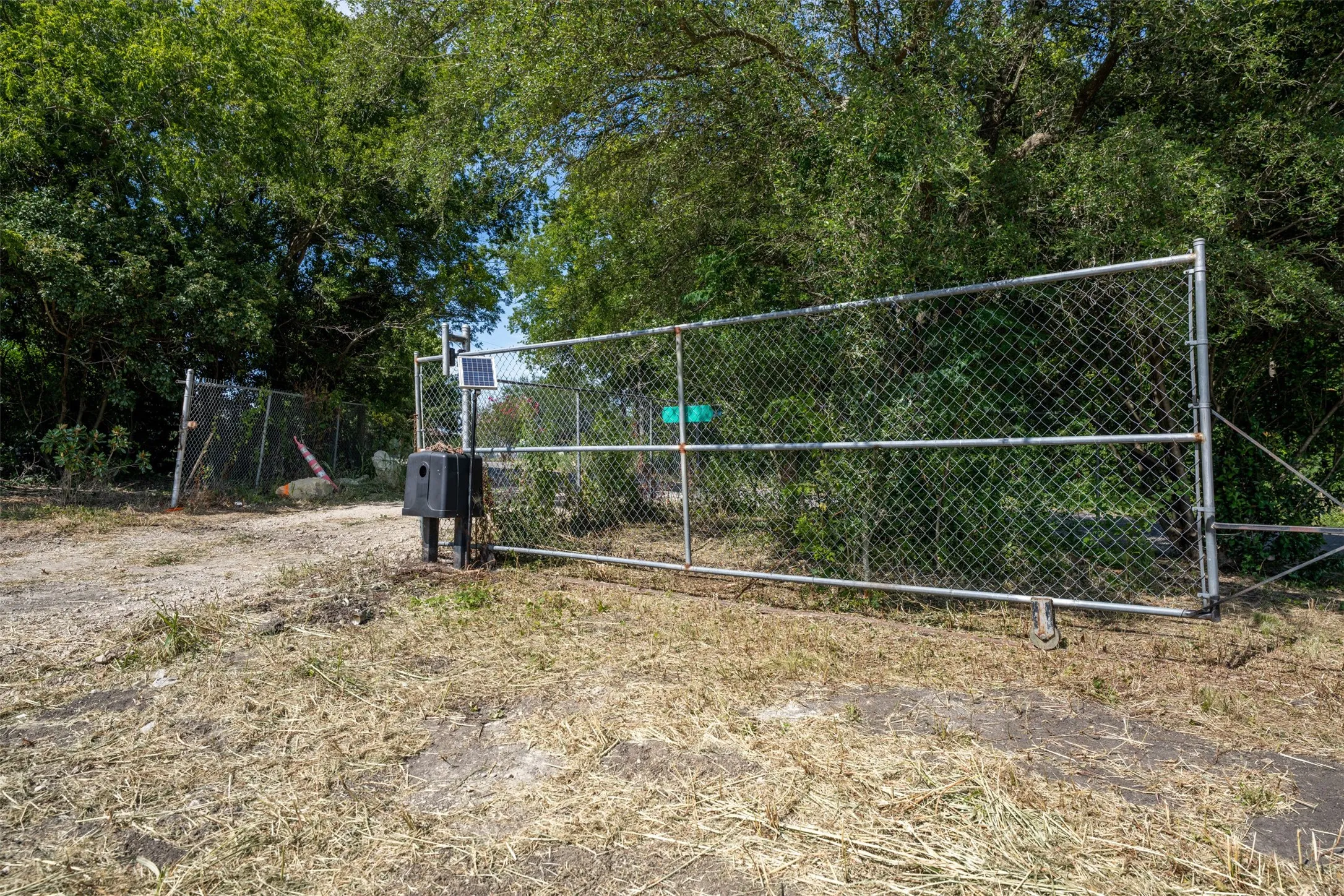 Chain-link gate entry with a solar-powered access control system