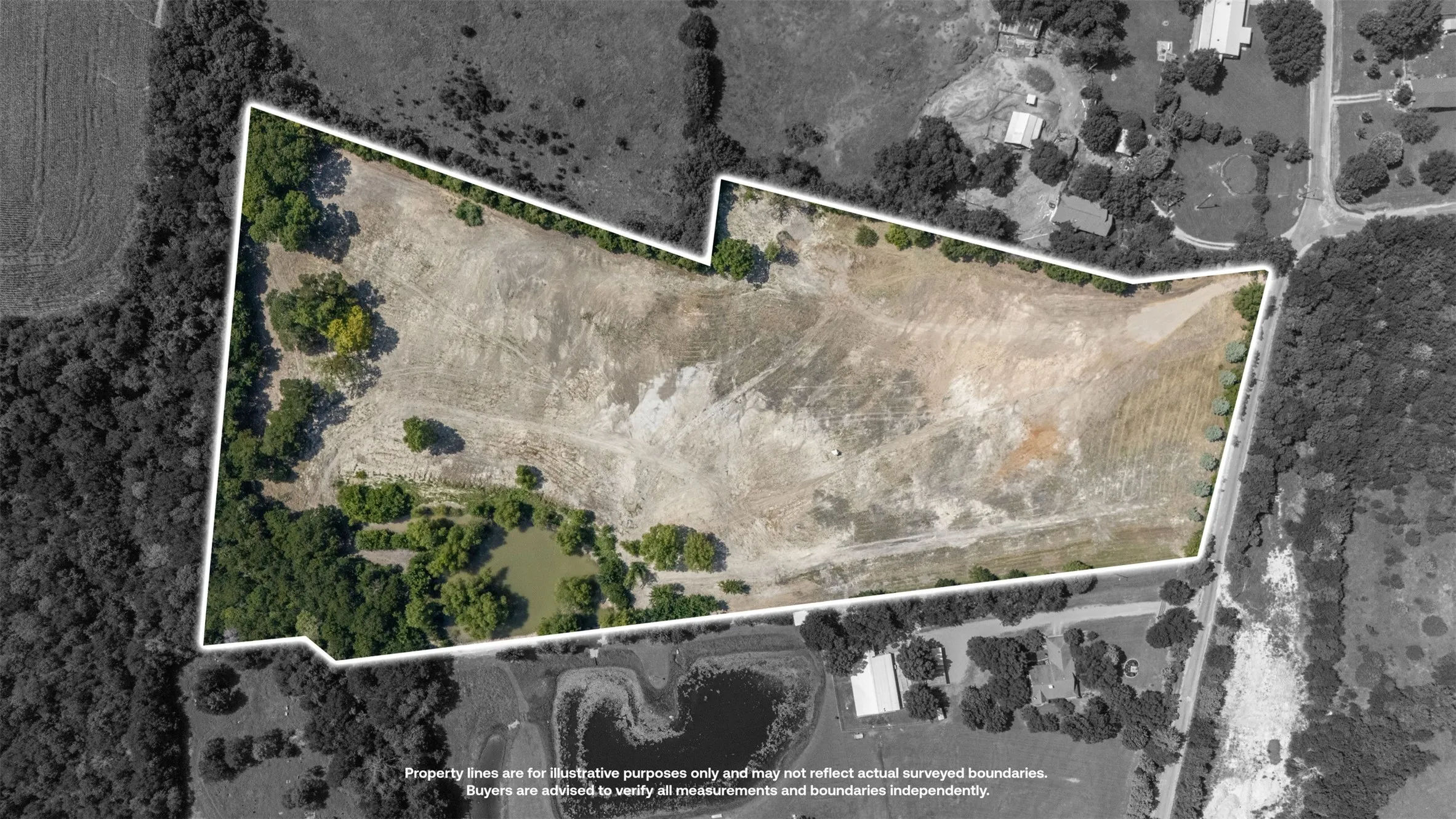 Expansive land parcel featuring a mix of open terrain and mature tree coverage