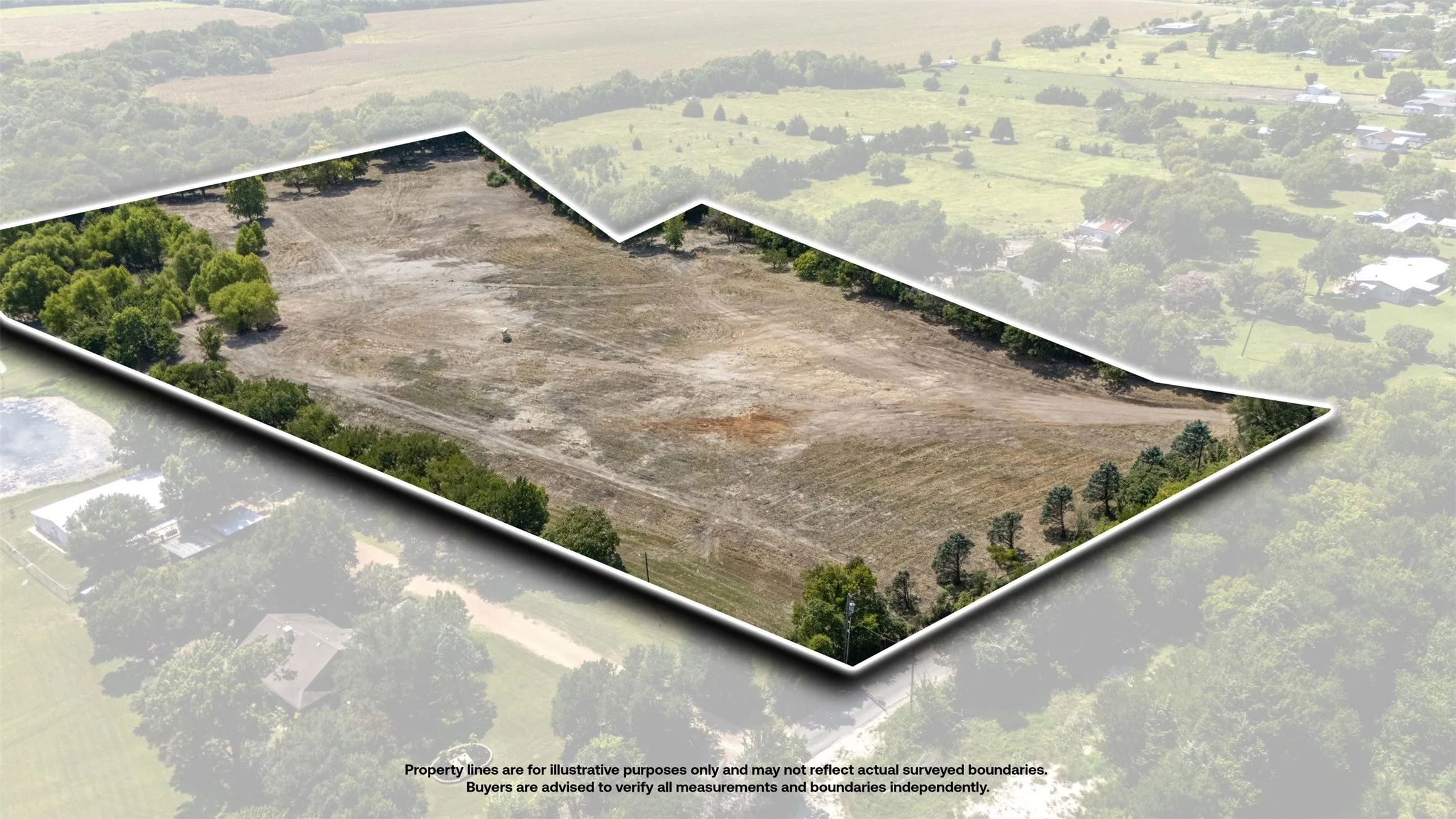 Expansive land parcel featuring a perimeter of mature trees, a clear central area, and a varied boundary line