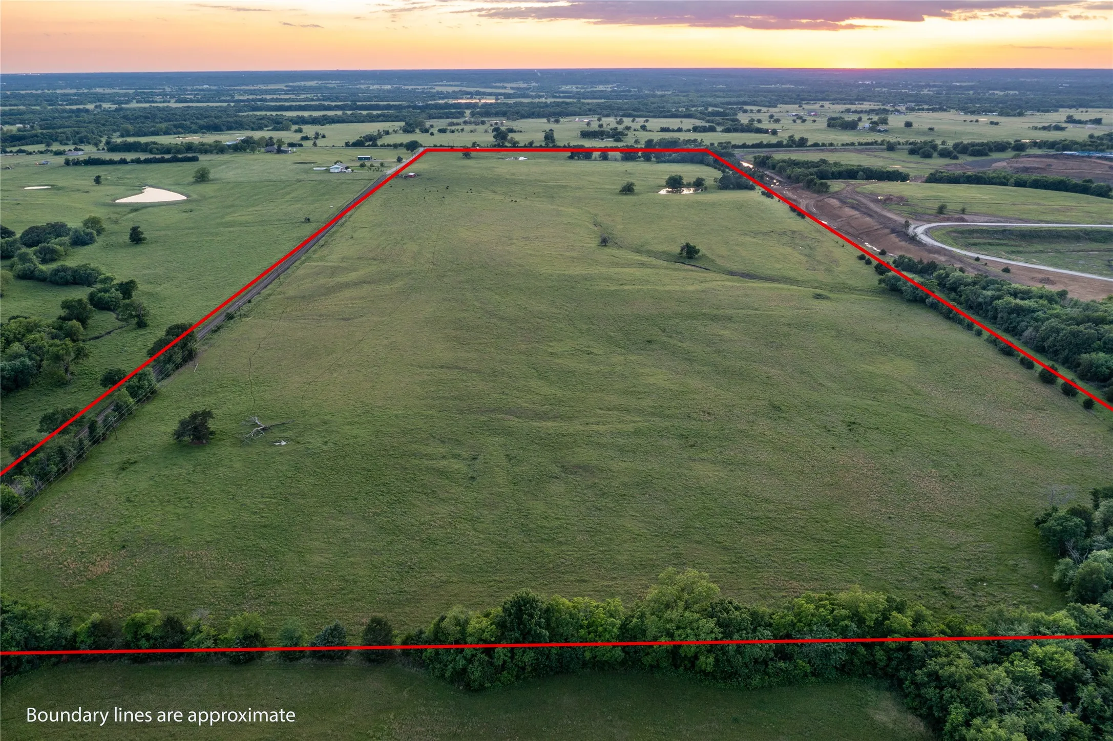Expansive green acreage with a distinct boundary line
