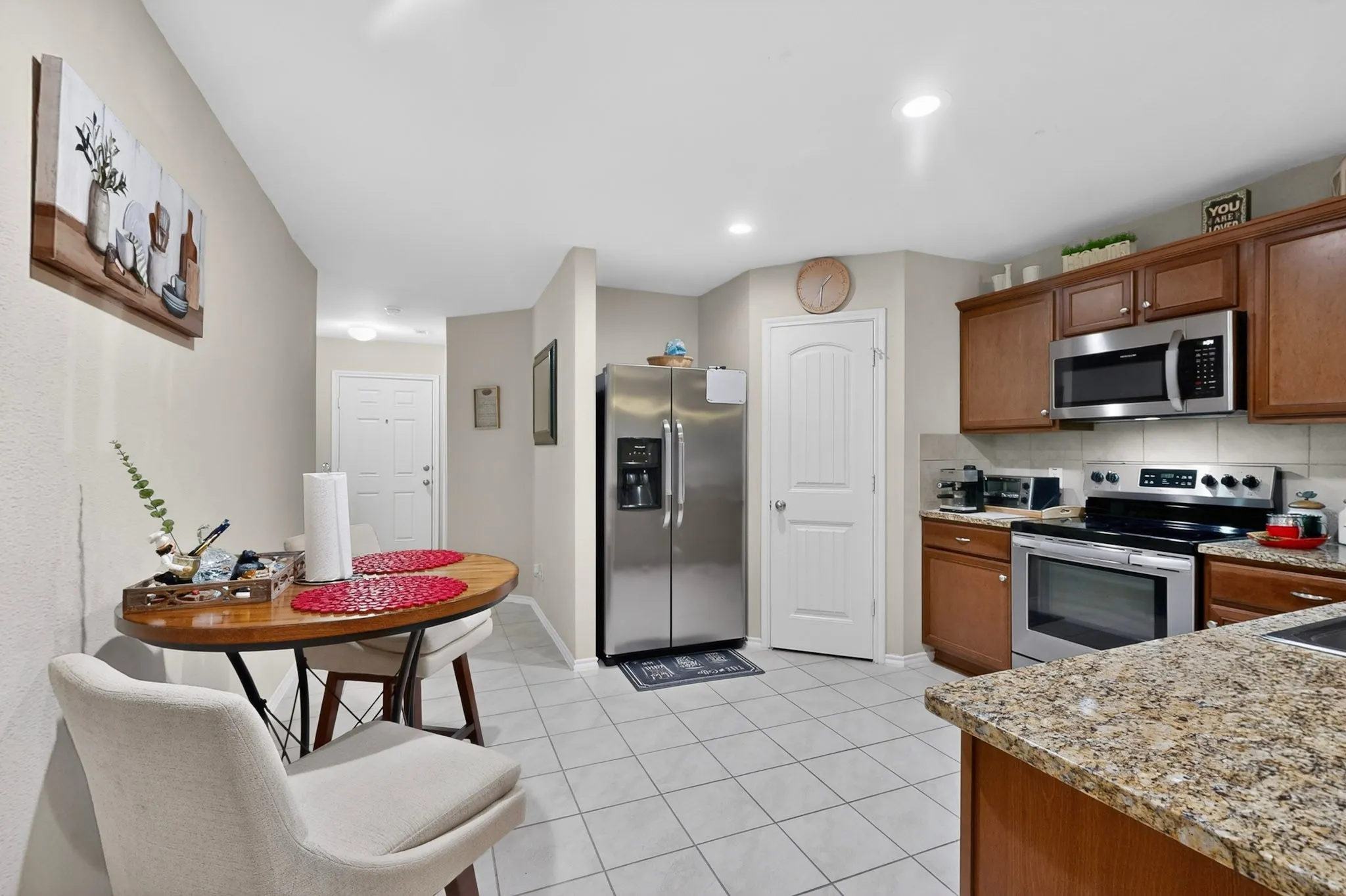 Kitchen featuring warm wood cabinetry, stainless steel appliances, and granite countertops
