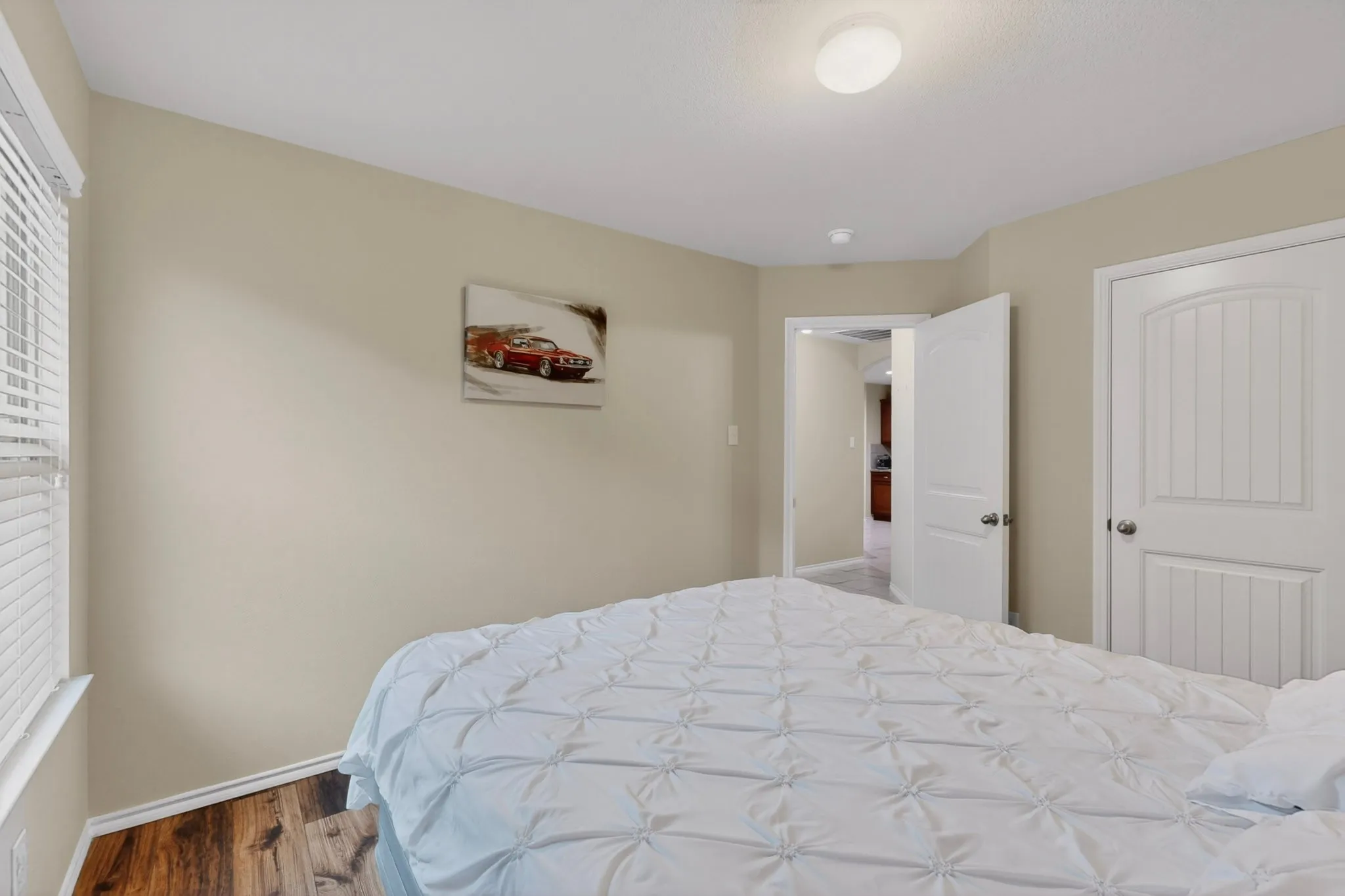 Bedroom featuring wood-finish flooring, neutral wall paint, and a recessed ceiling light fixture
