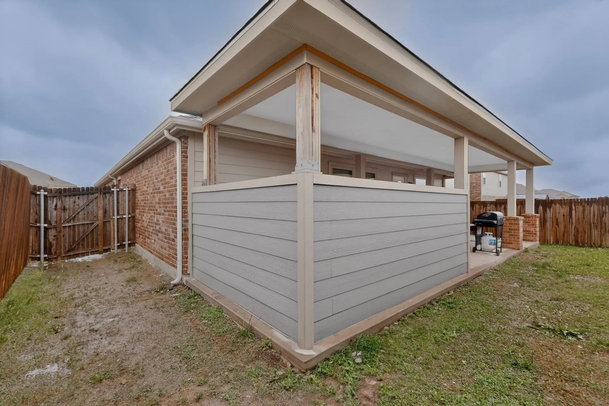 Covered patio featuring a concrete slab and support columns