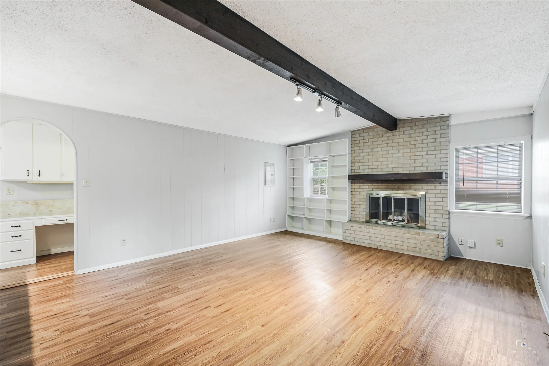 Another view of the family room with a lovely arched doorway for easy access to the kitchen which has a nice desk as an extra workspace or for homework - easy access to laundry-mudroom and walk in panty utility.