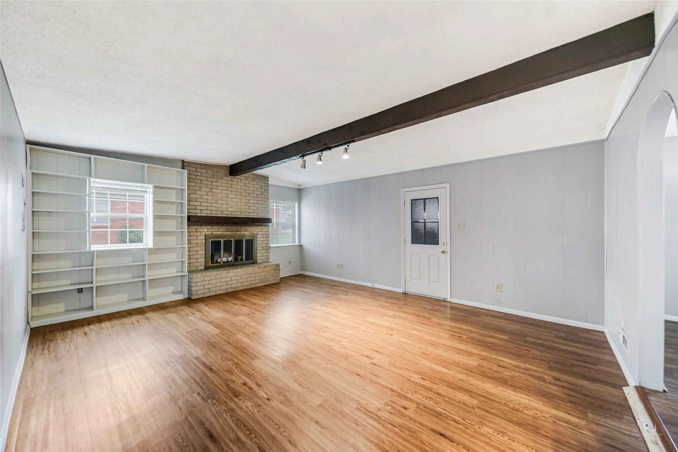 Window coverings for entire home! Built-in bookcases and a wood burning brick fireplace with fireplace coveriing ideal as well as the raised brick fireplace - additional seating, nice wood mantle- easy to hang Christmas stockings, etc... create your own space! And ideal for pets and children or those with allergies to carpet!