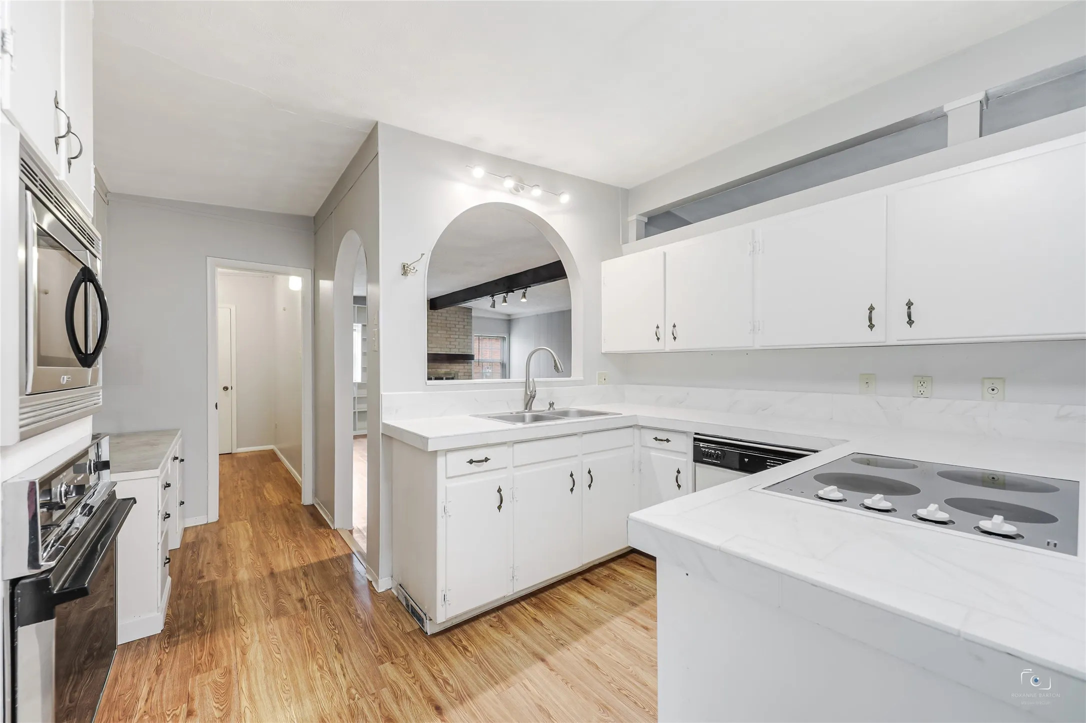 Ideal access through the kitchen to your laundry room and nice sized pantry with extra door for easy access to your outdoor area! Kenmore Elite stainless microwave! Hotpoint Oven! Maytag dishwasher! Maytag cooktop! Vent fan overhead cooktop! Arched window pass through to family room!