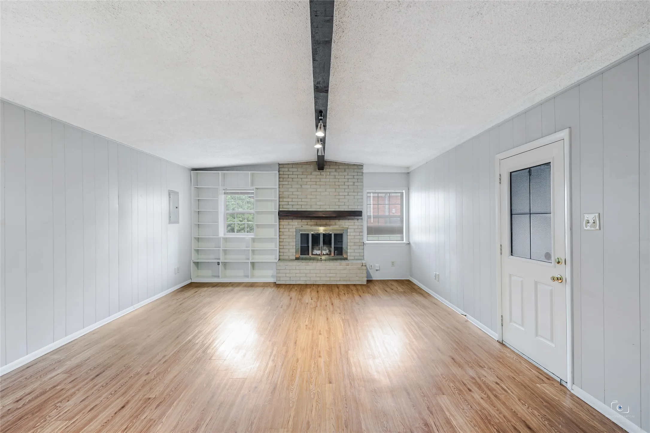 Spacious second  living area is spacious and offers built-n bookcase, wood burning brick fireplace, wood mantle, beamed ceiling and easy accessto kitchen and garage!  You will find this floorplan is well appointed with no wasted space with the SFT.