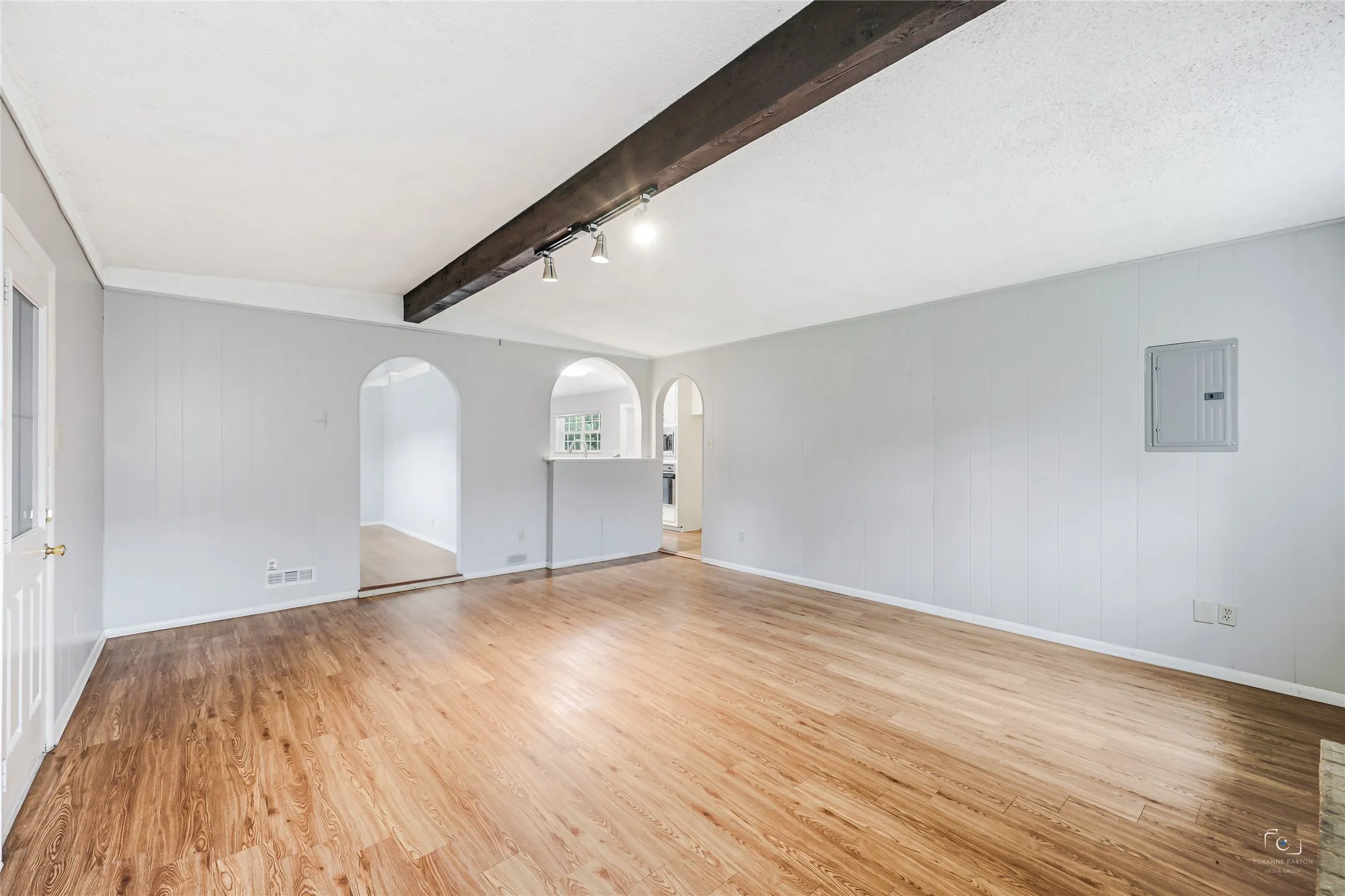 Lovely views of the arched doorways and arch pass through to the kitchen with additional views of the wall flooring and electric panel!   This is a great investment for home ownership , 1031 exchange or an investment property due to its location to Ft Worth and growing e