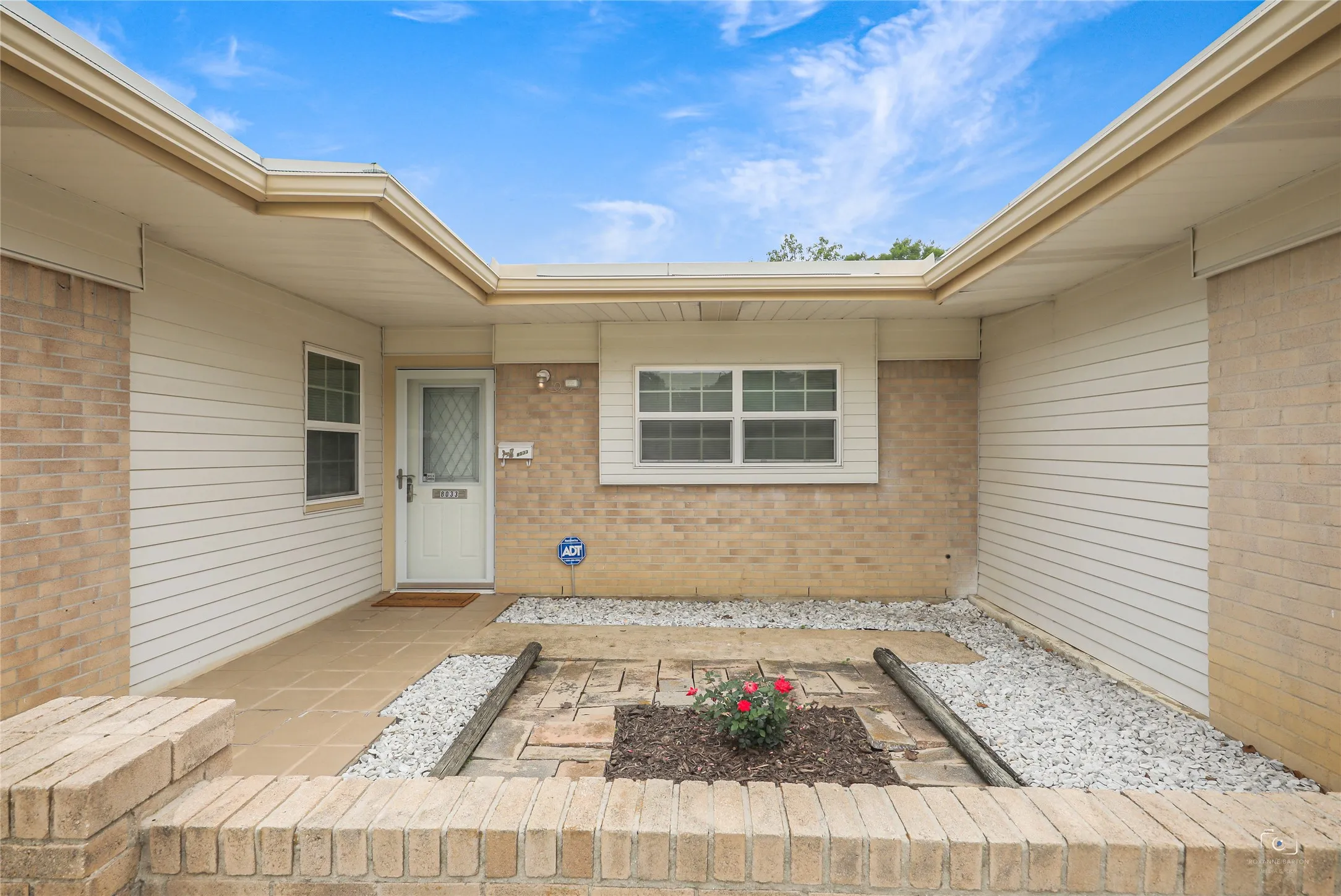 Lovely front courtyard in this mid century mdern feel home- Pella windows throughout, TPO Roof, gutters, window coverings,---ready for immediate move-in!