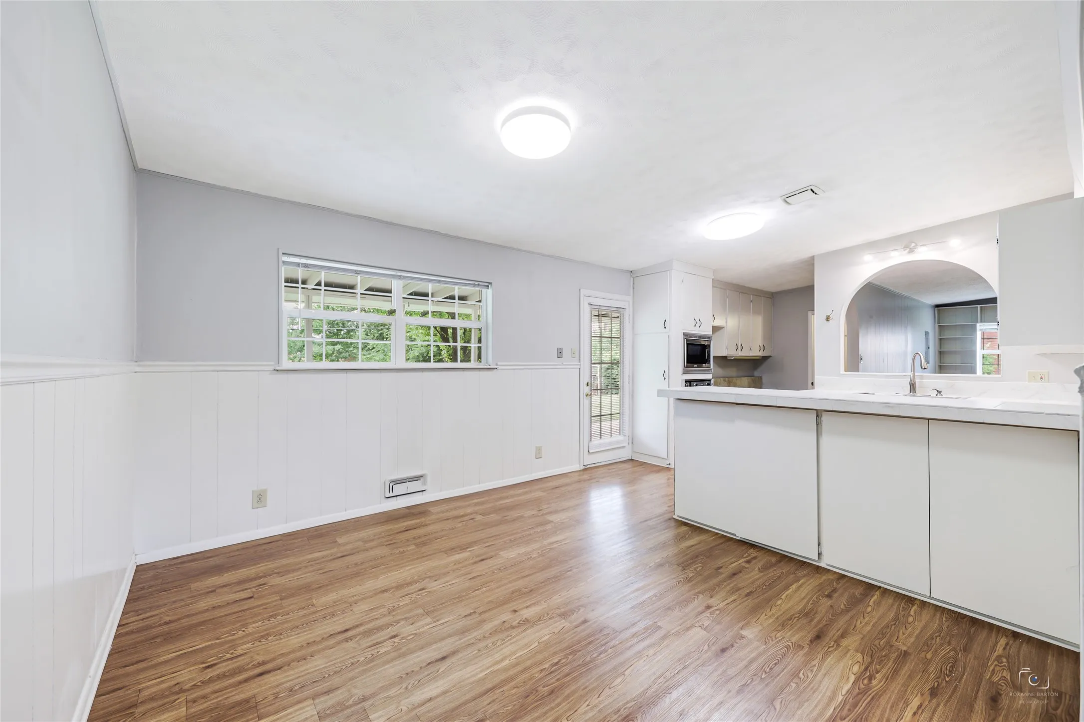 Dining area with easy access to fence backyard!  Pella windows have window coverings and offer natural light with easy access to your kitchen!