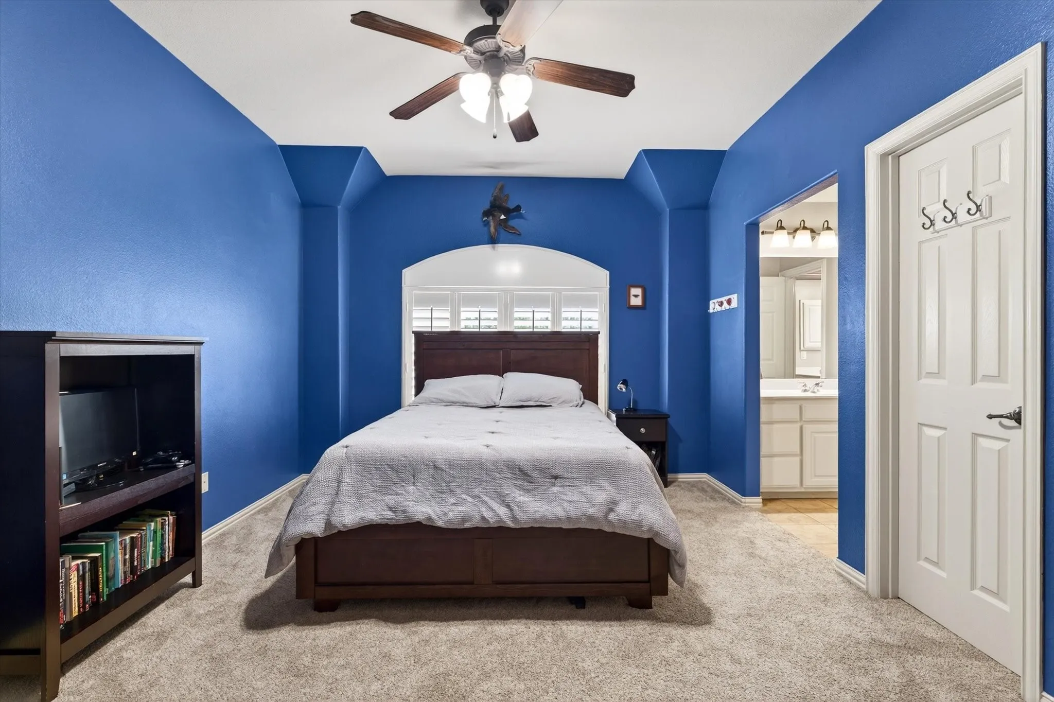 Another spacious upstairs bedroom offers vaulted ceilings, a walk-in closet, and plenty of room for guests or family.