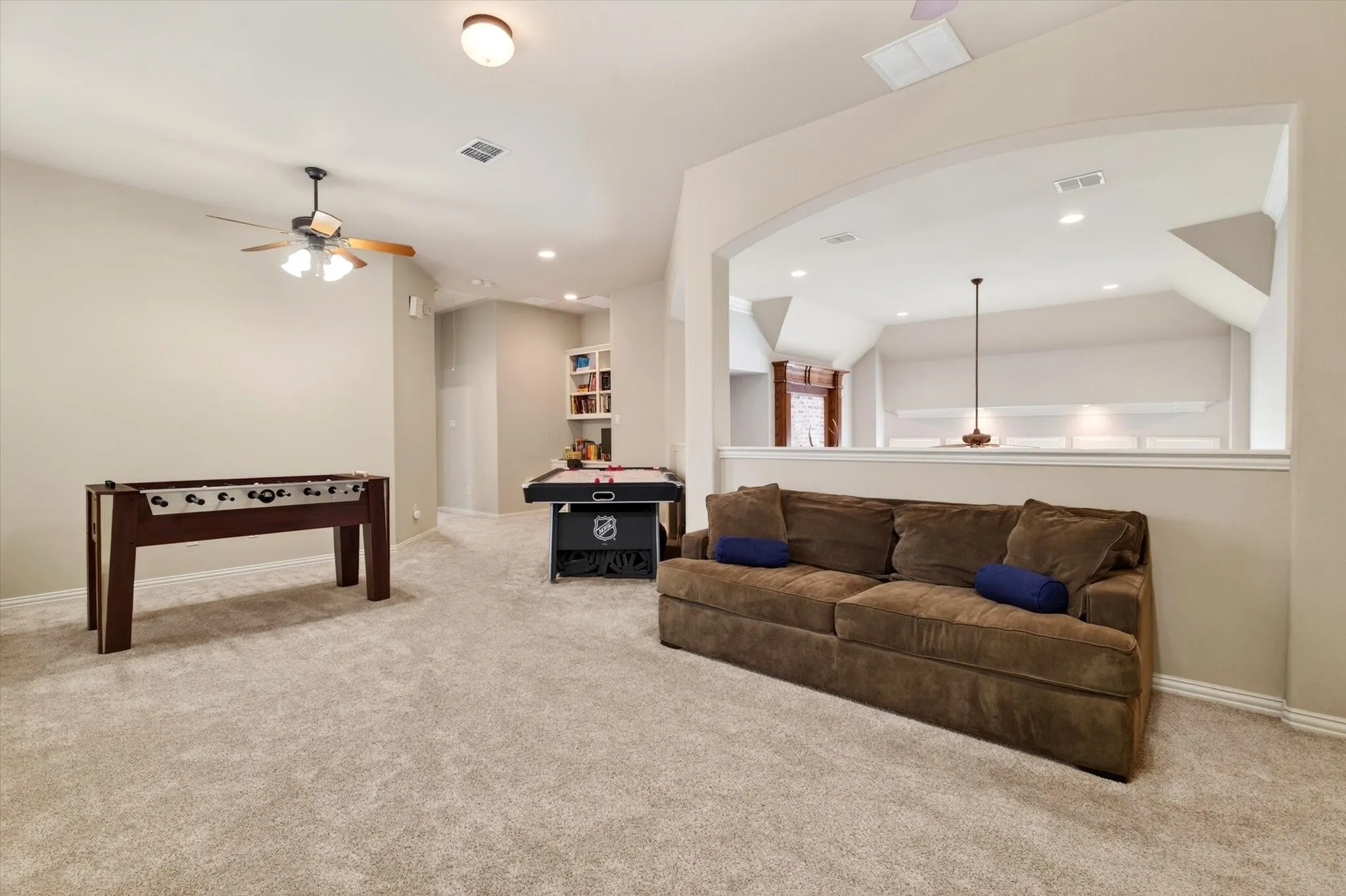 The upstairs living area offers flexible space for a pool table, sectional, homework zone, or teen retreat.