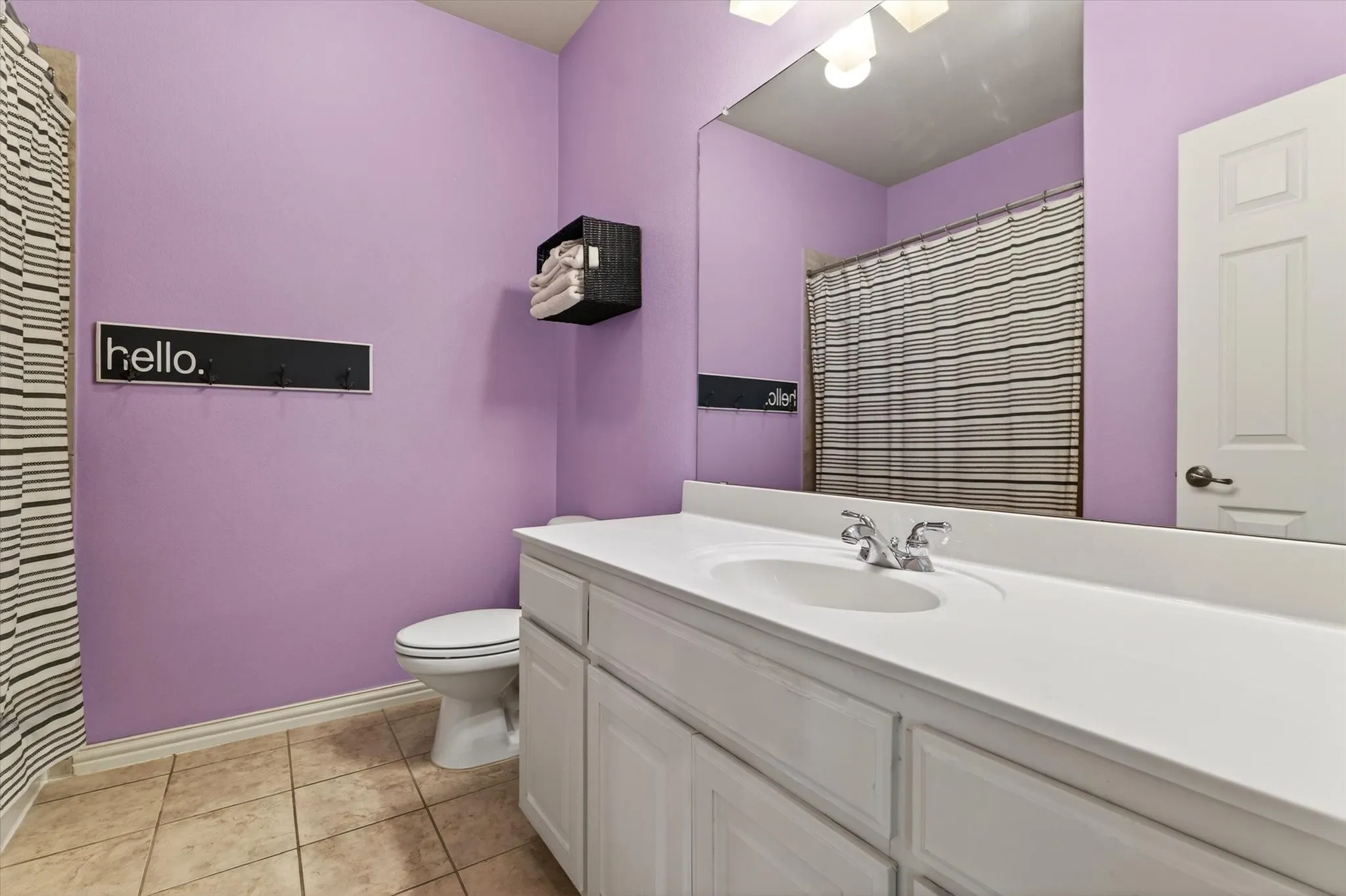 The upstairs bath adds color, personality, and function, serving nearby bedrooms with ease.