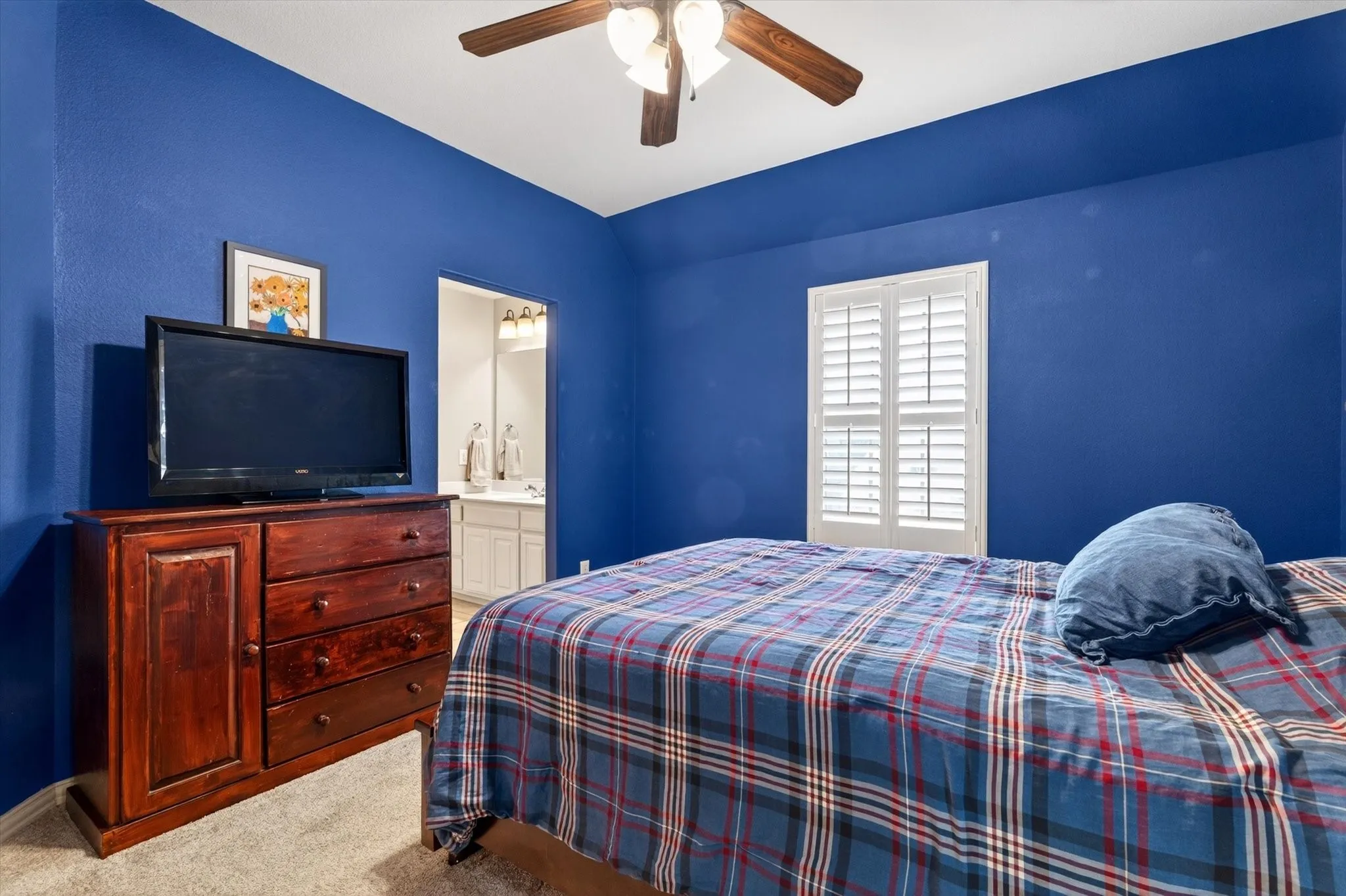 A bold upstairs bedroom with plantation shutters and great closet space gives personality without sacrificing comfort.