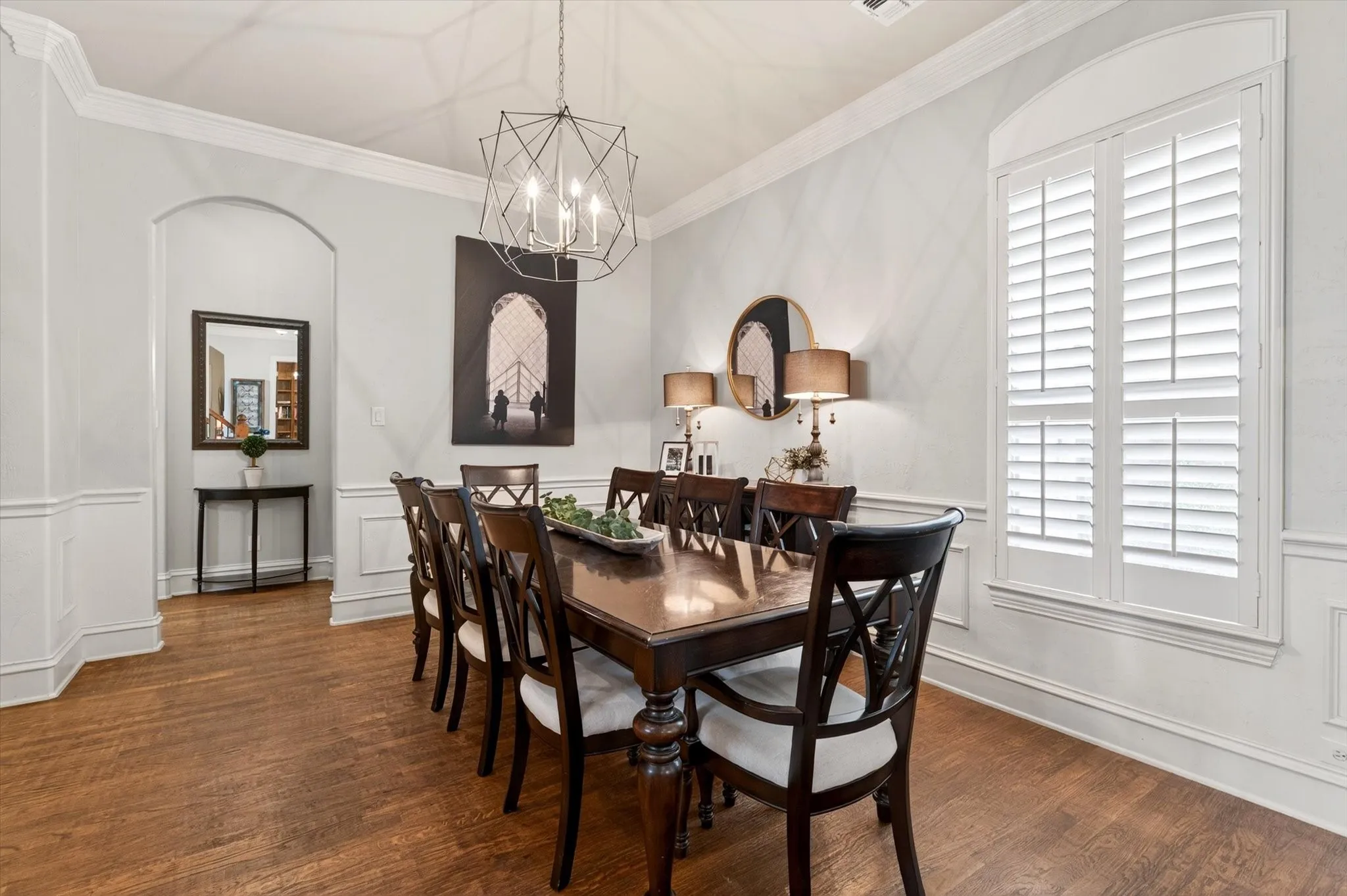 The formal dining room offers elegant molding, hardwood floors, and space for holiday dinners, celebrations, and the occasional over-planned tablescape.