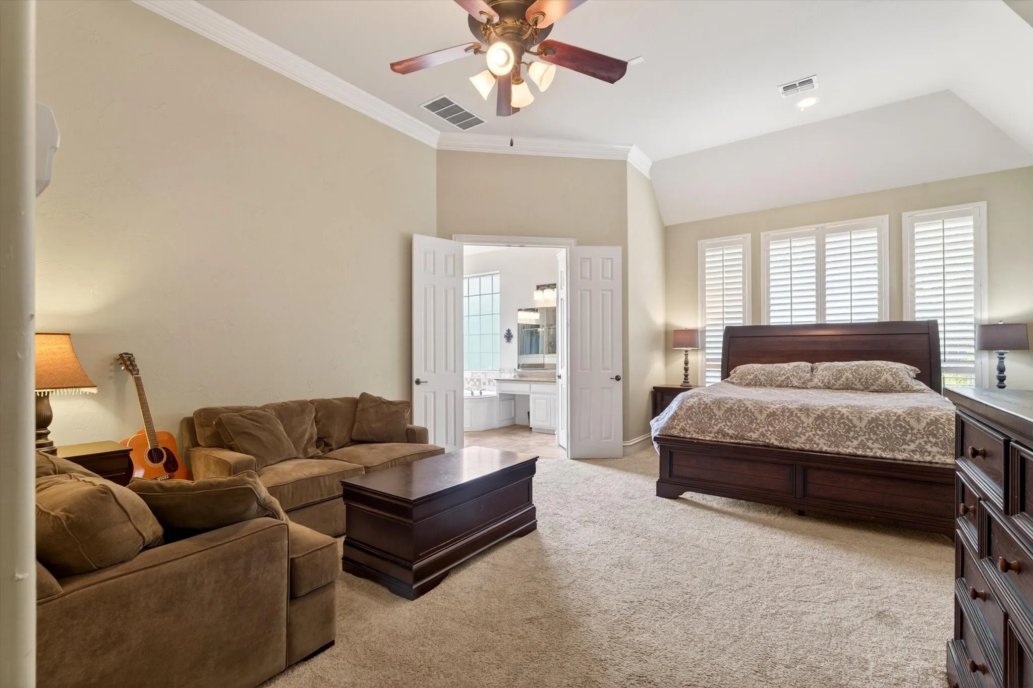 The Texas-sized primary suite offers space to unwind with a sitting area, soft natural light, and room for oversized furniture.