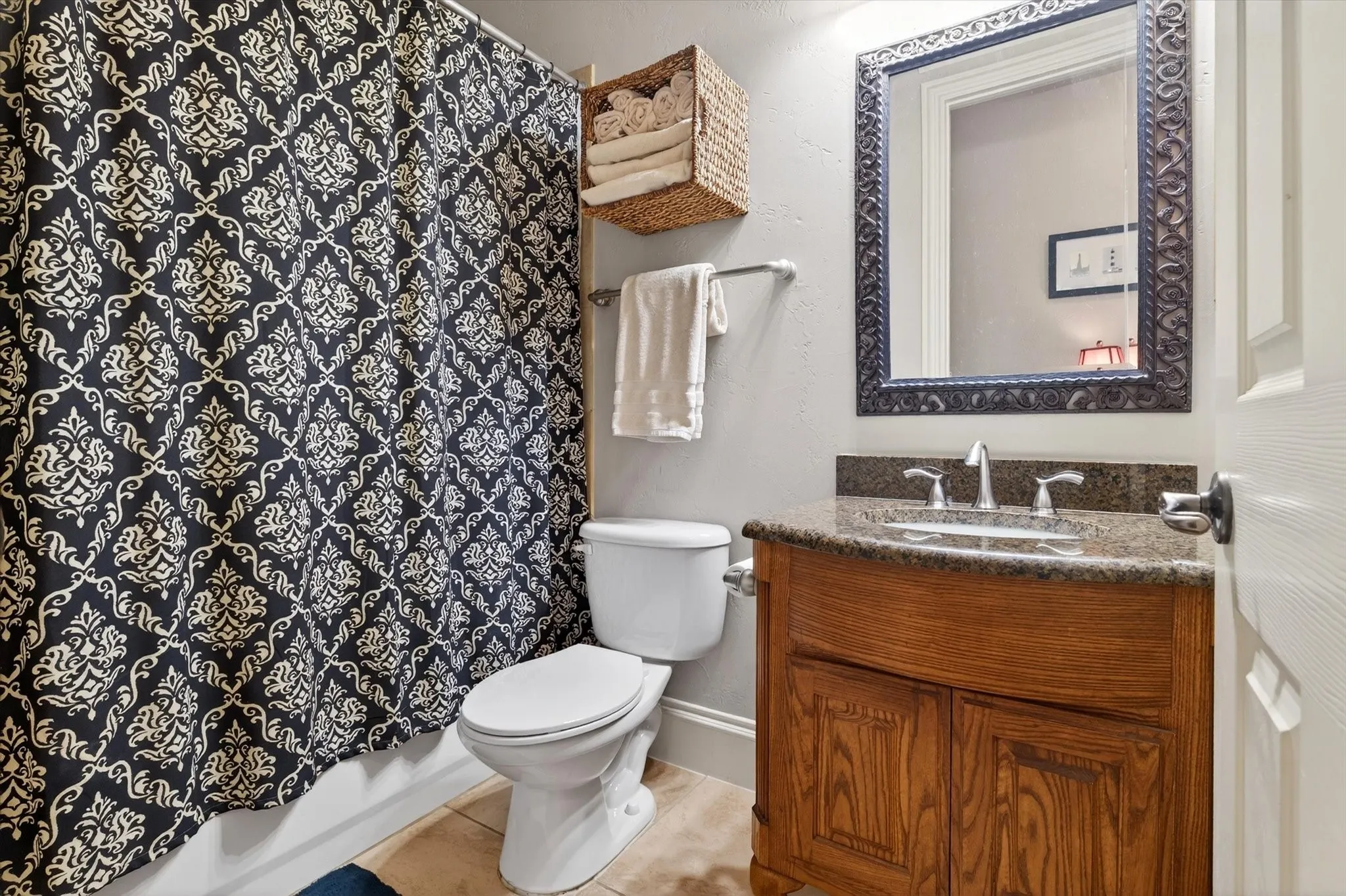 A full bath near the secondary main-level bedroom adds convenience and privacy for guests or everyday use.