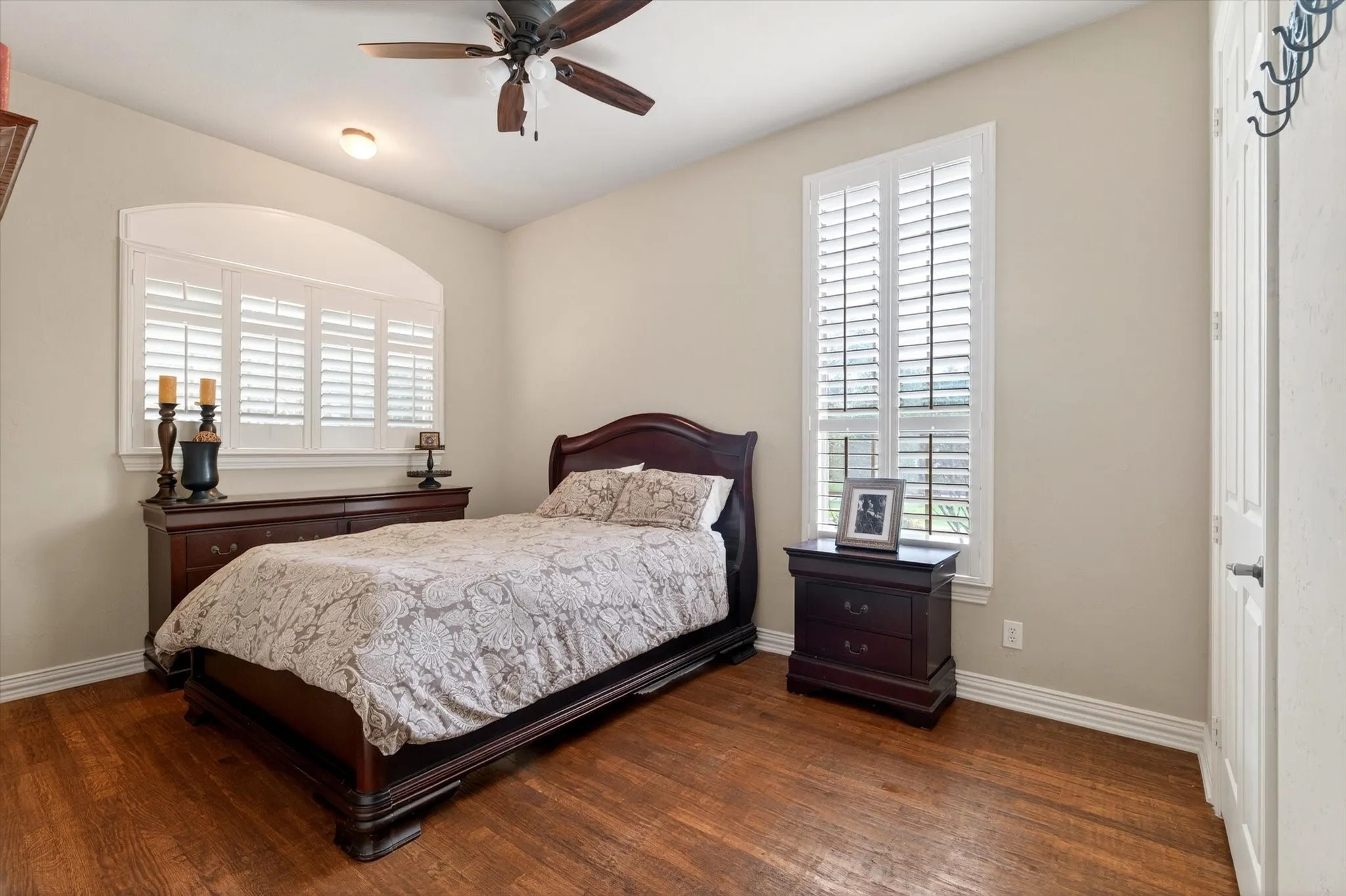 A main-level secondary bedroom offers flexibility for guests, family, or anyone who appreciates not climbing stairs at the end of the day.