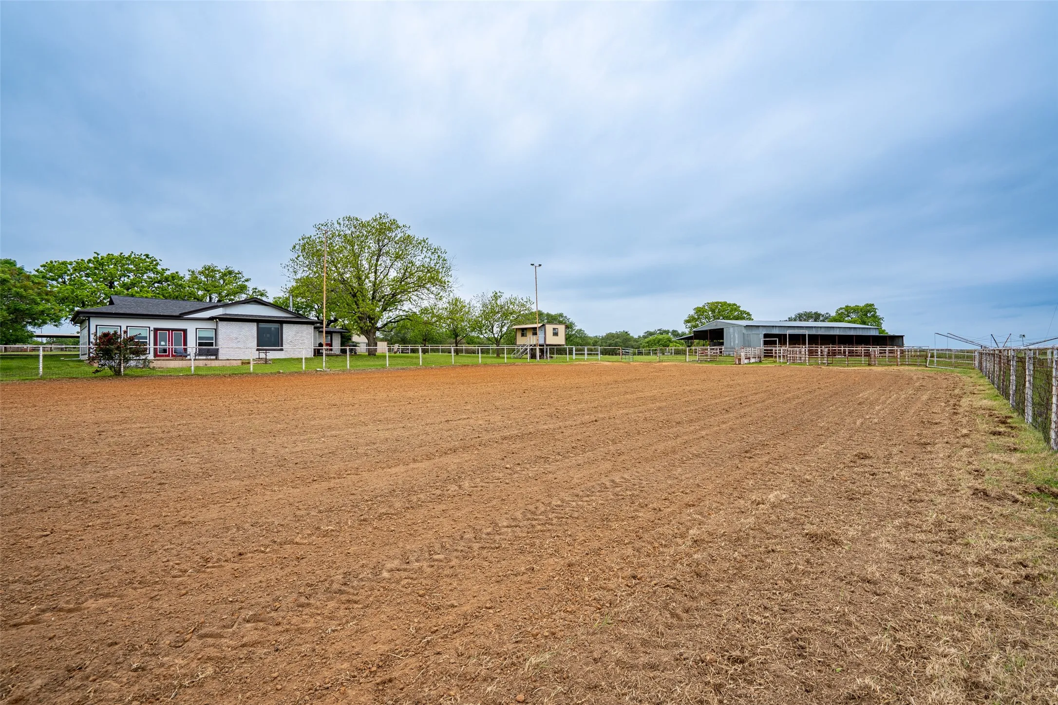 Expansive riding arena with a fenced perimeter