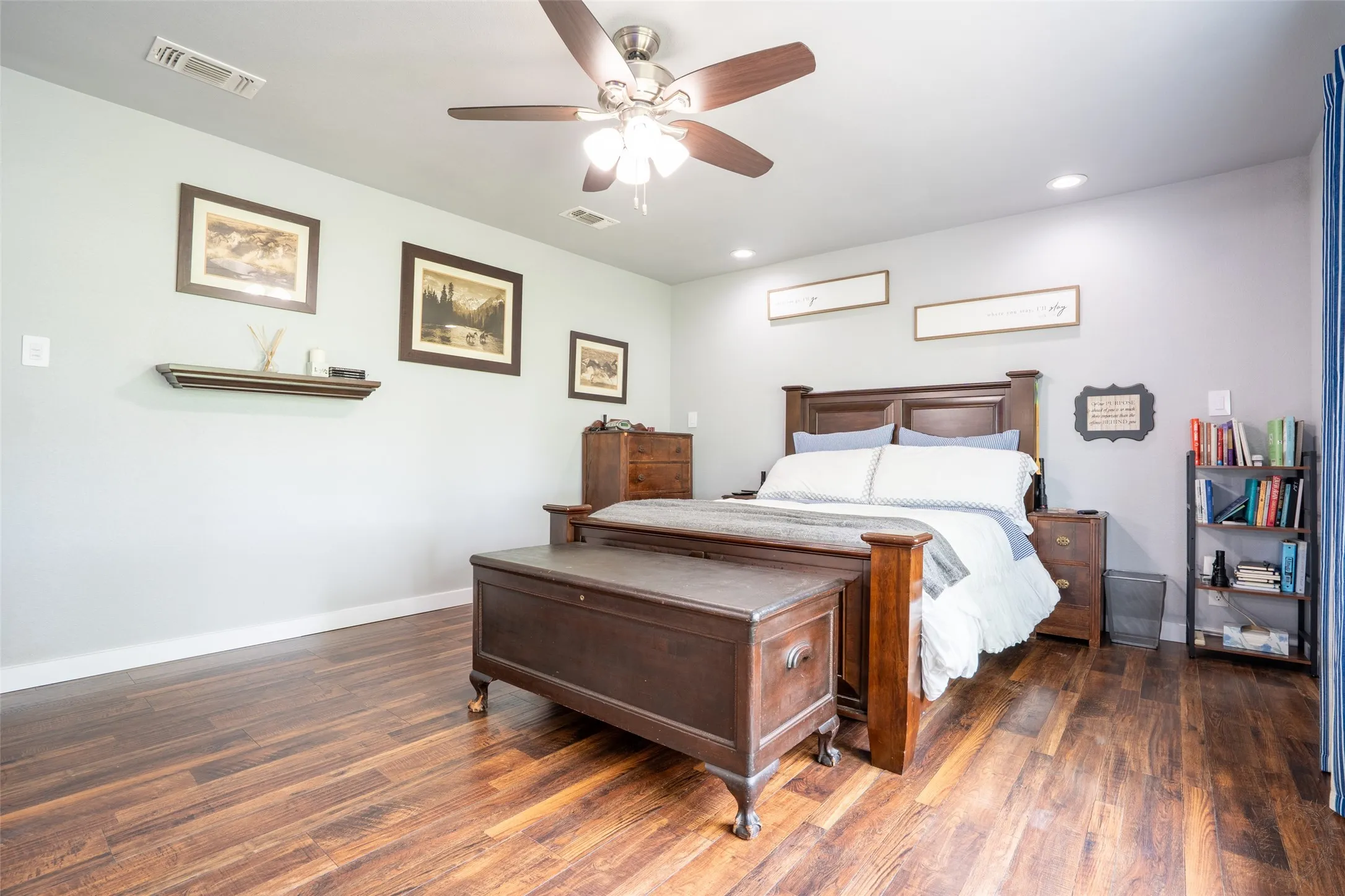 Master bedroom retreat featuring wood-finish flooring, light gray walls, and recessed lighting