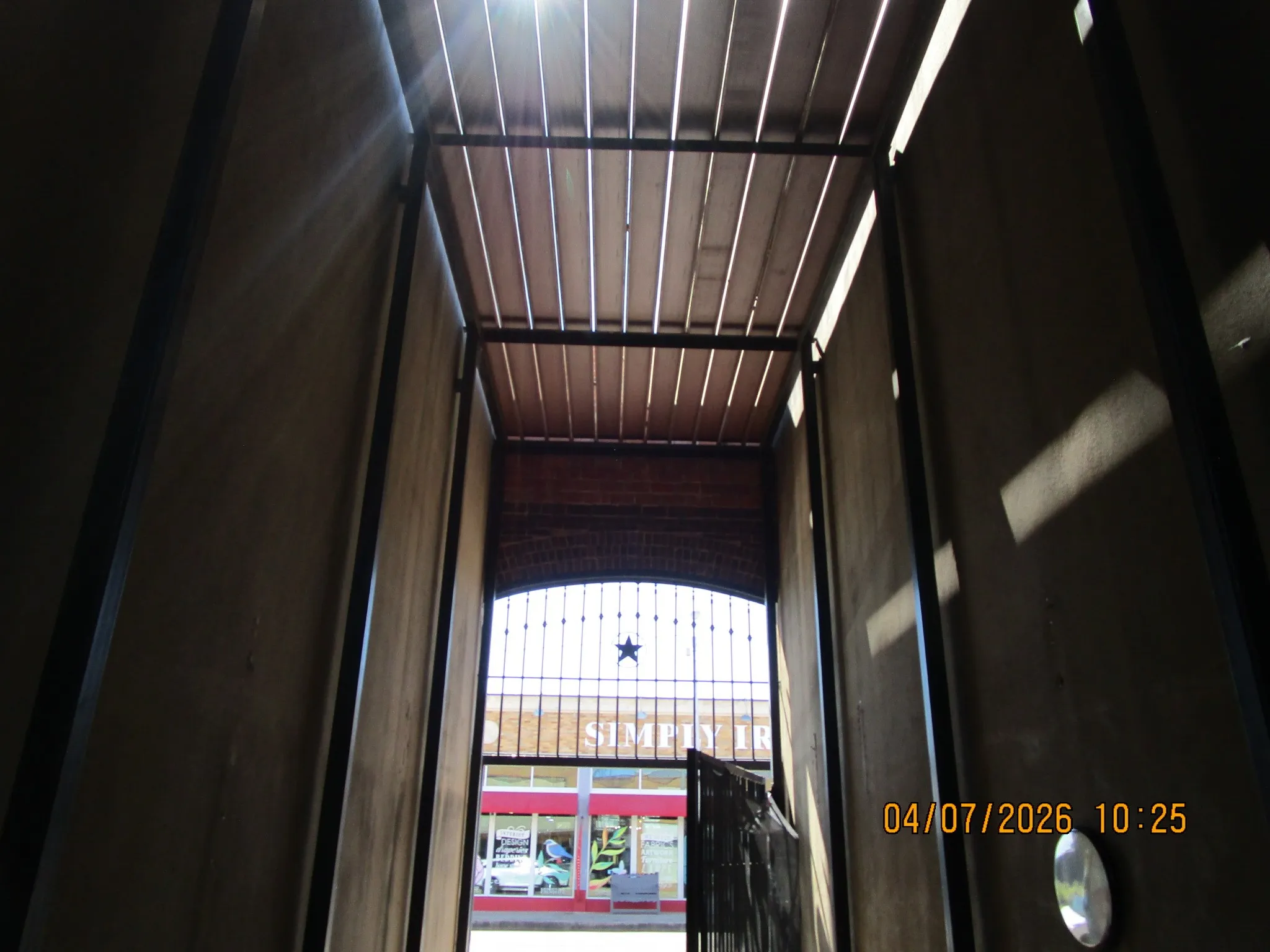 under balcony facing street