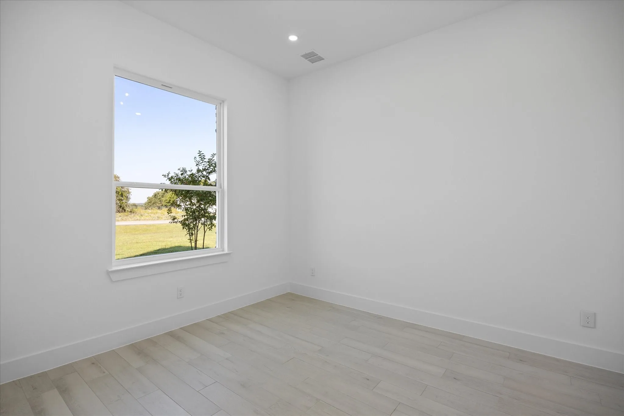Front facing Study Room featuring a large window, light Porcelain Tile-finish flooring, white walls, recessed lighting, and white baseboards