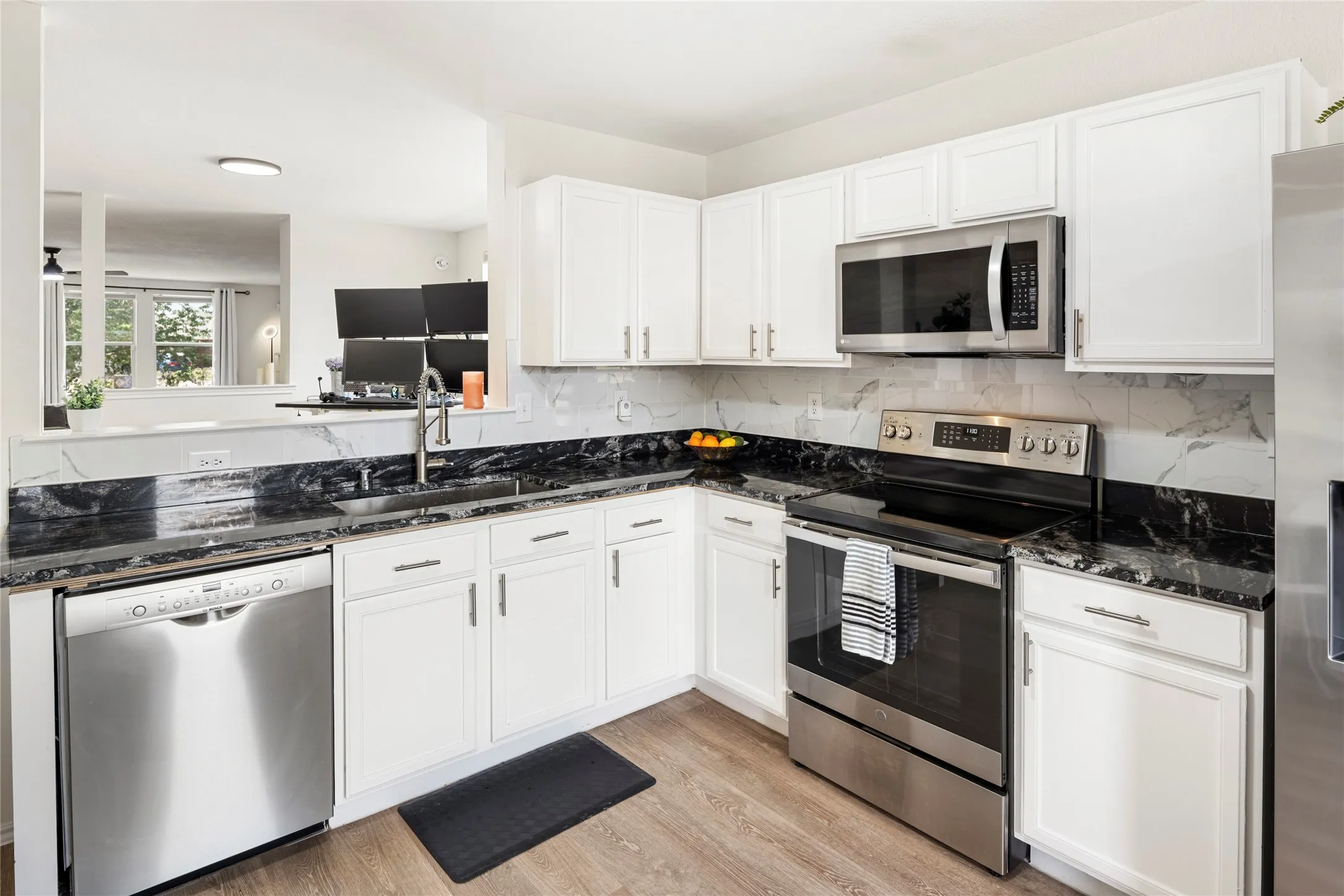 Large single basin sink, updated stainless steel appliances....view out the front window from the kithen....very open space.....