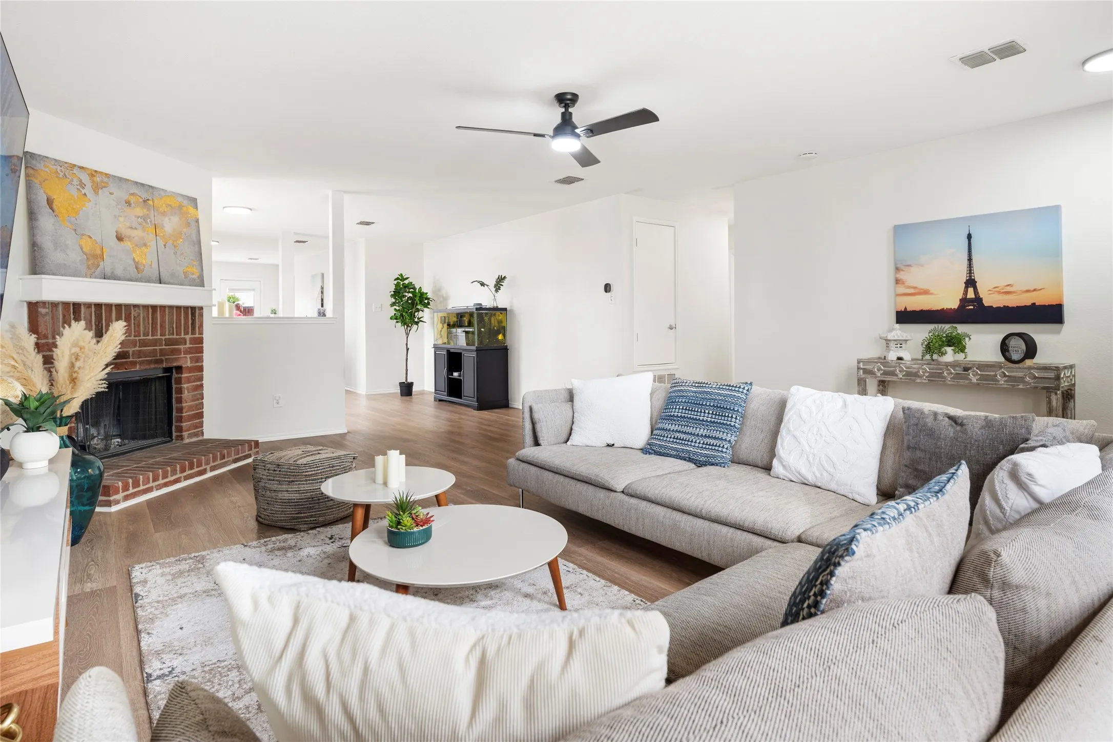 The brick fireplace adds a cozy feel and lovely contrast to the light color walls.....